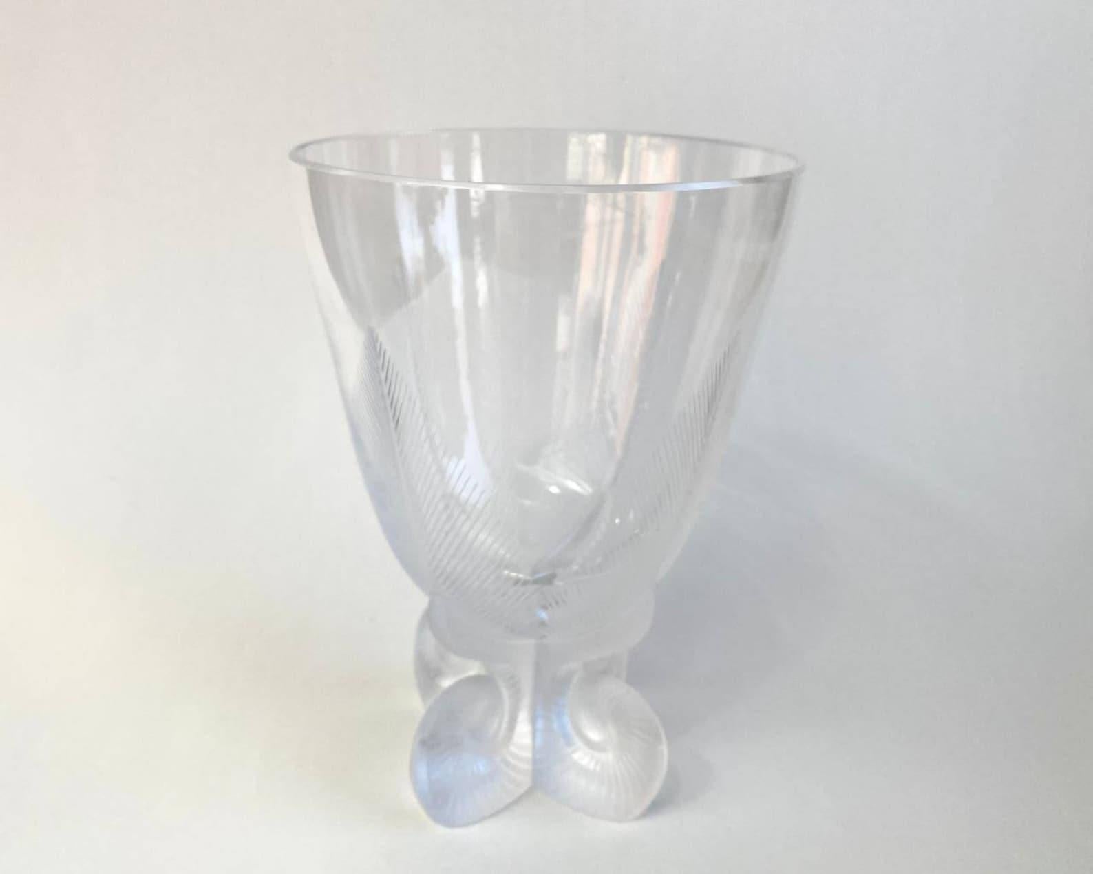 Lalique Osmonde fern leaf frosted vase with legs. 

 The vase has four feet on the base and is decorated with cut fern leaf designs. It is a high quality clear and frosted crystal. It is marked on the bottom - Lalique, France.

 The model is