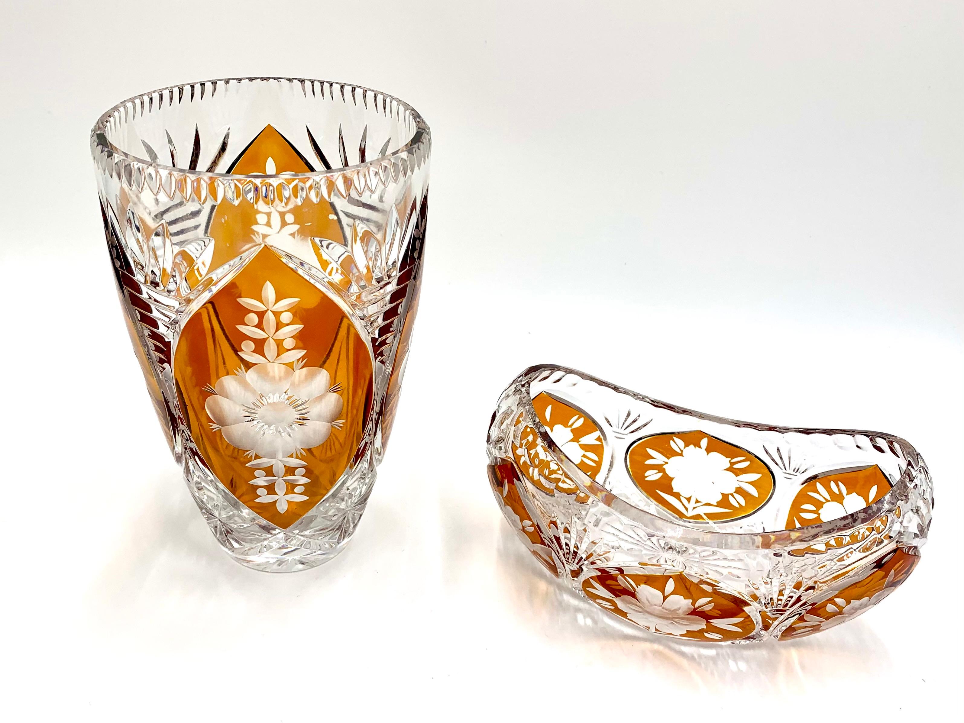 A set of a vase with an oblong bowl for sweets.

Made of crystal, produced in Poland in the 1960s.

Vase height: 21, diameter 12 cm

Bowl: 10cm high, 17cm wide, 10cm deep.