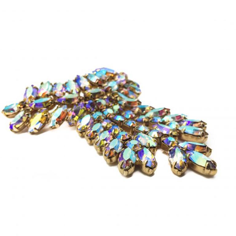 A stunning 1950s Vintage Opaline Aurora Borealis Brooch in a drippy medal style. Featuring the most incredible shimmering crystal marquise and chaton cut stones. Set in claw set, gold tone metal mounts. In very good vintage condition. Measuring