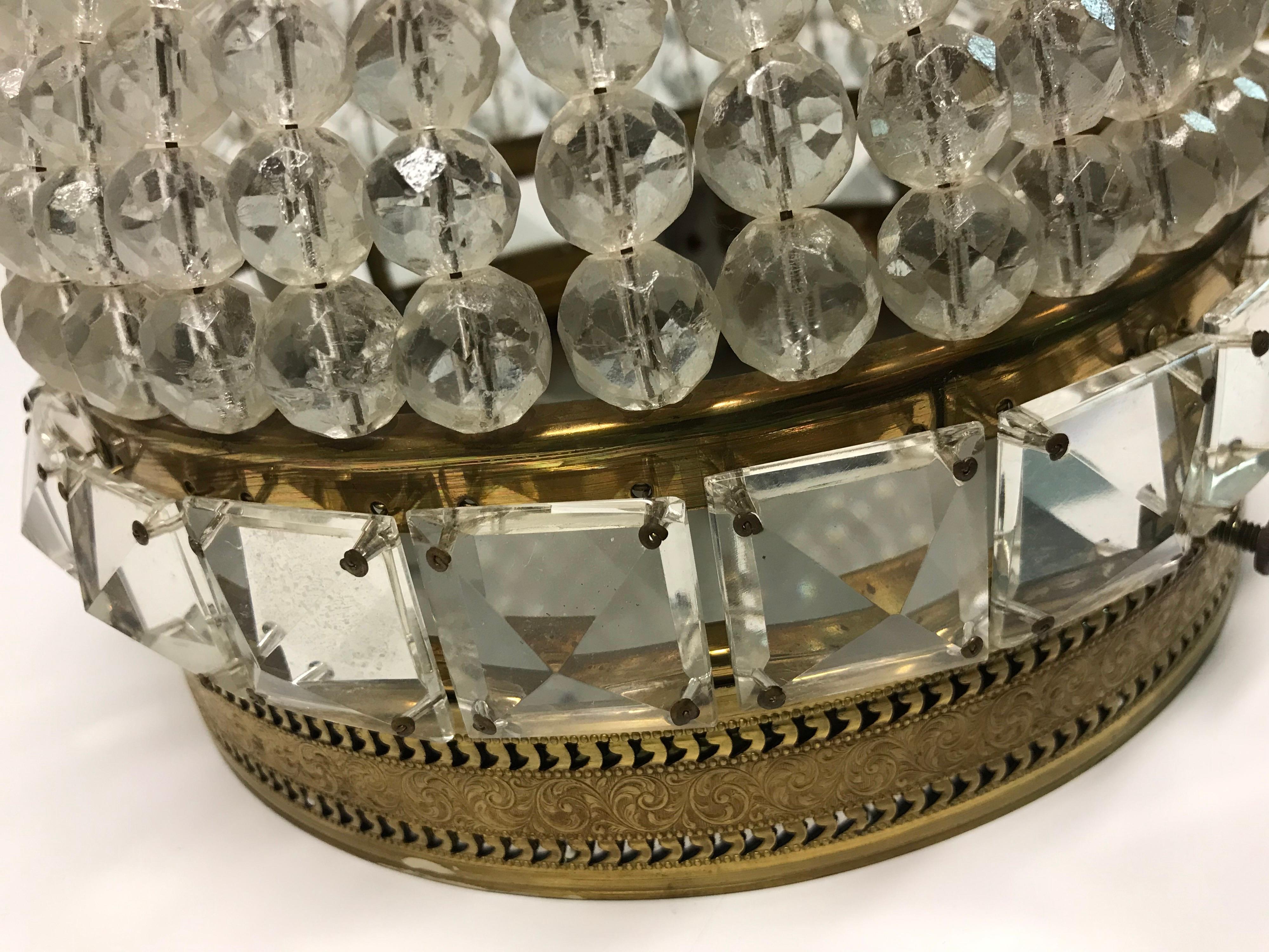 This is a pair of round crystal vintage flush mount coordinating fixtures They are probably from the 1950s-1960s and have original wiring the banding is brass colored pierced metal and the crystals are round beading and square crystals surrounding