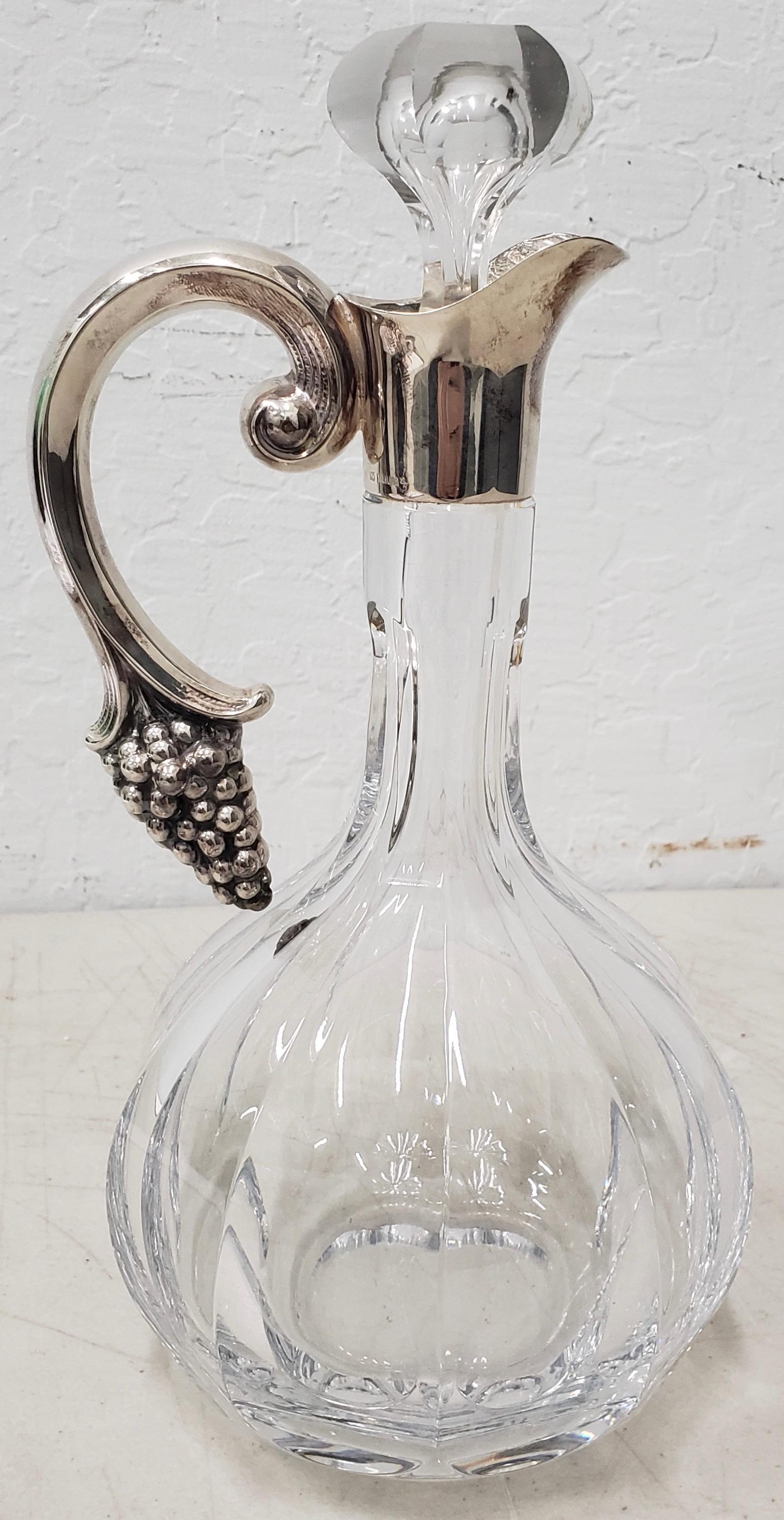 Crystal wine decanter with sterling silver handle

Beautiful wine decanter with a sterling silver handle with a bunch of grapes.

No chips. No cracks. Absolutely gorgeous.

Dimensions 6