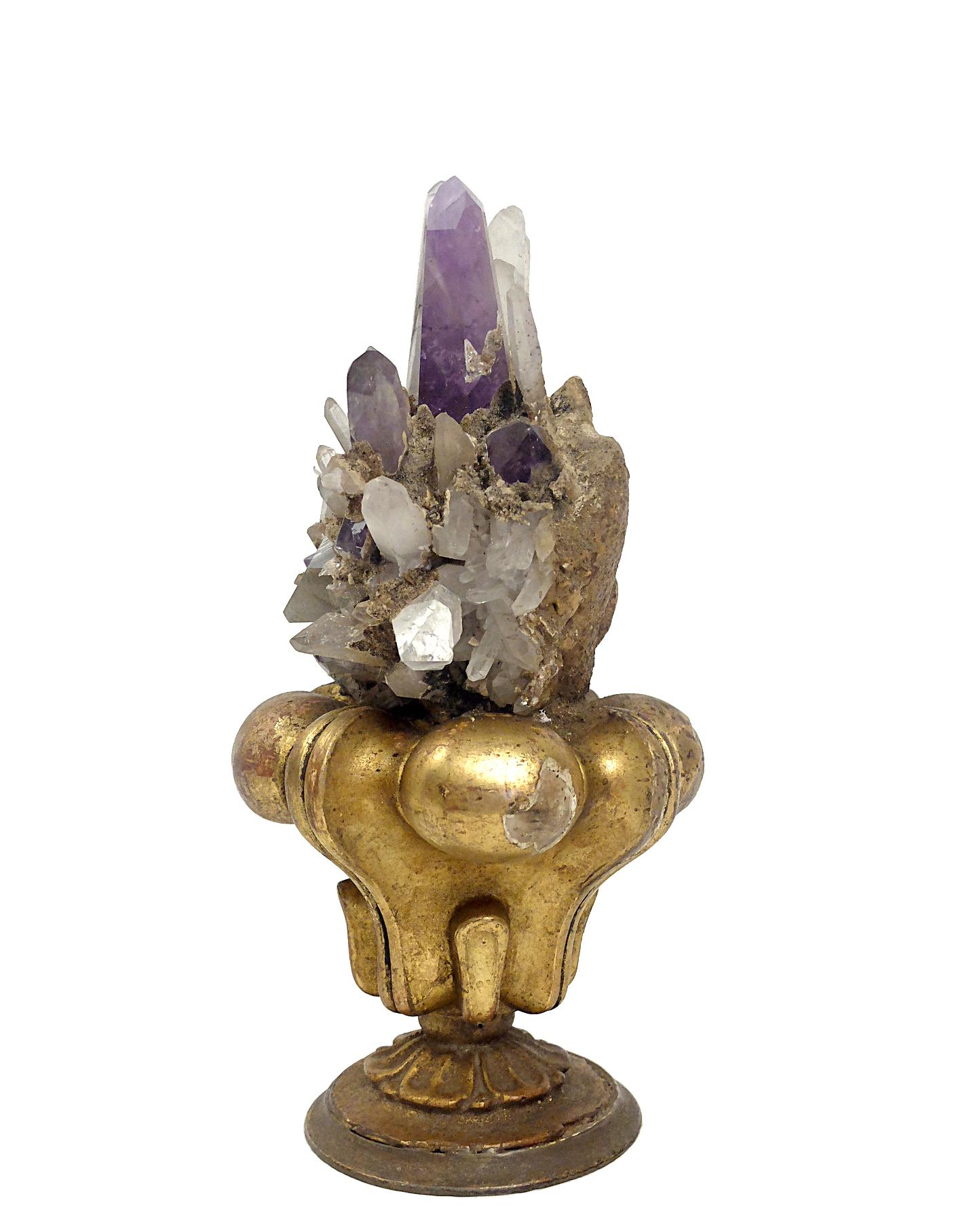 A Naturalia mineral specimen. A Druze of rock crystals and amethyst crystals. The base used to be a palm holder during the Palm Sunday. The crystals samples are mounted over the base surrounded by gilded wooden globular elements. This exceptional