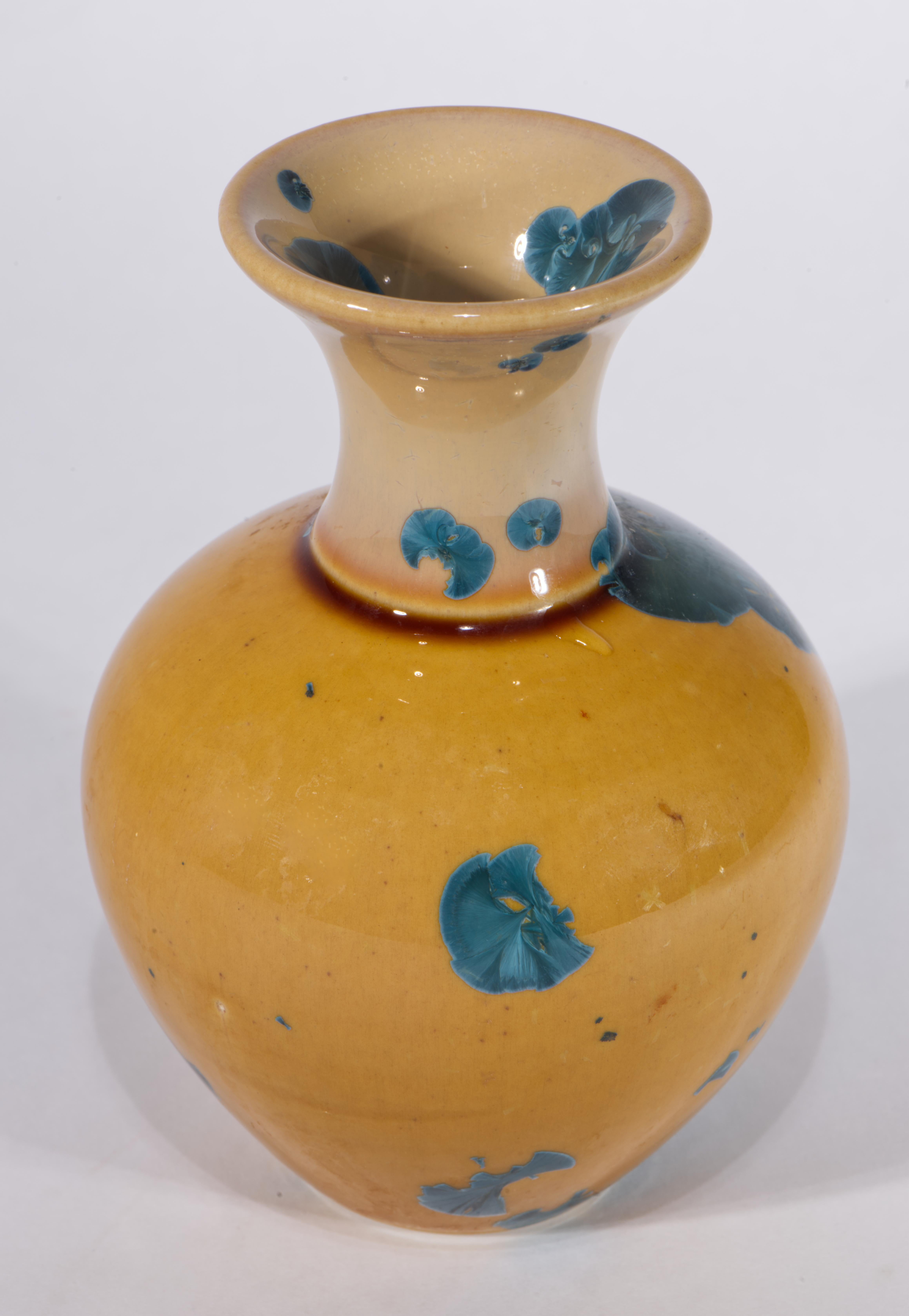 The striking vintage studio pottery ceramic vase is decorated with crystalline glaze in contrasting blue and mustard yellow colors. The vase was hand thrown on a wheel; blue color crystals on ombre colored base, shifting from ligher shade of yellow