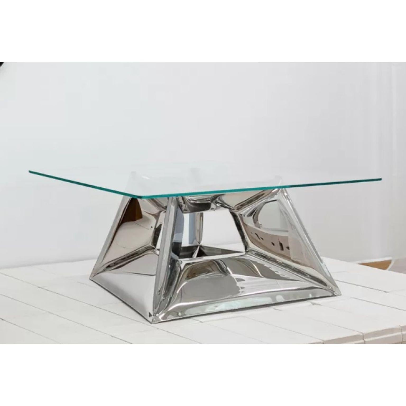 Crystals Coffee Table by Zieta
Dimensions: D 80 x W 130 x H 45 cm.
Materials: Glass and polished stainless steel.

Inspired by diamonds
The steel base of the CRYSTALS coffee table curves the surroundings in its mirrored surfaces like a kaleidoscope.
