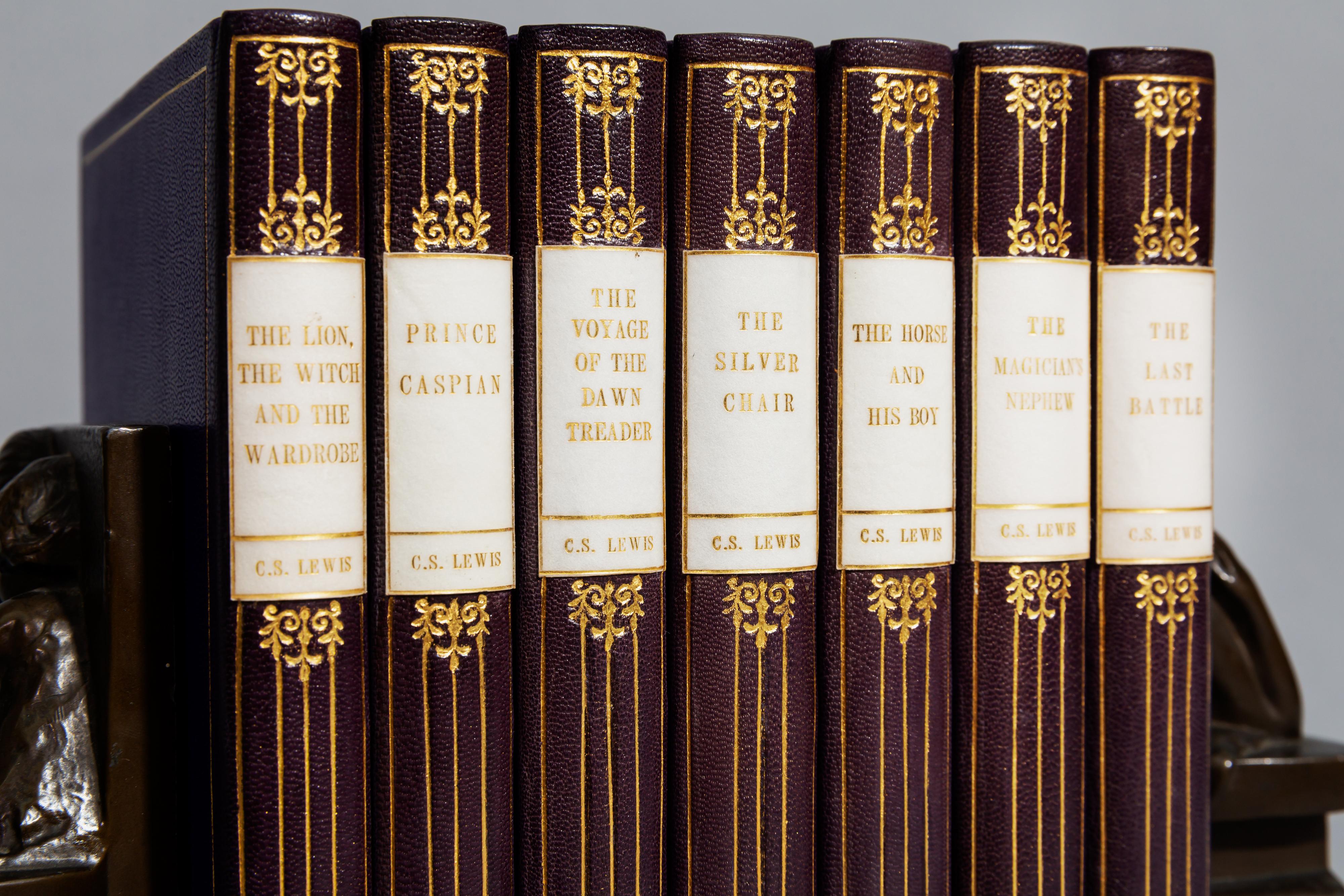 7 volumes. 

Illustrated by Pauline Baynes. Rebound in Full purple Morocco by Temple Bookbinders, smooth back, vellum title/author label on spine small vellum date label to foot, two unequal panels with volute tools to health ad foot joined by