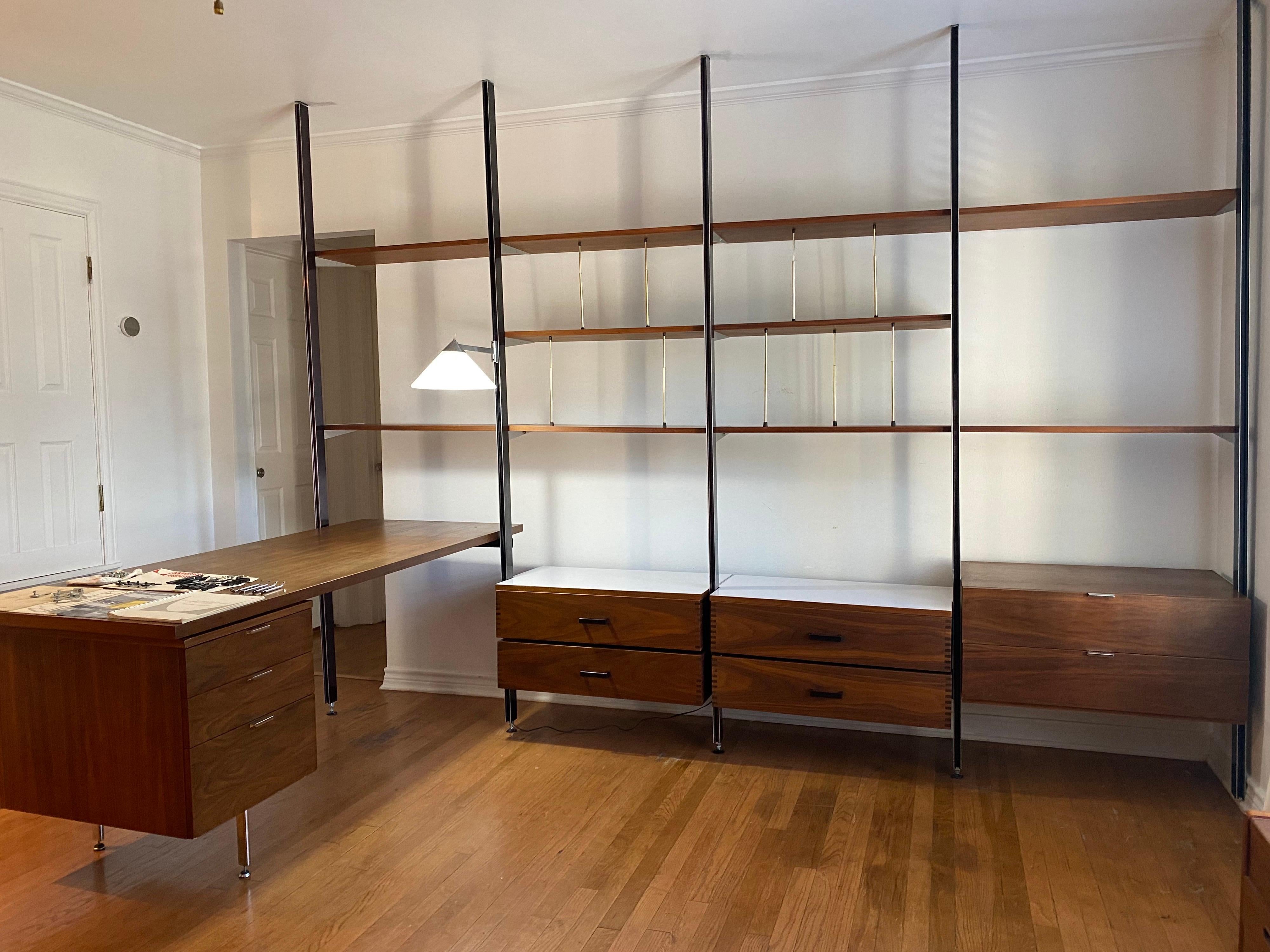 Beautiful Mid-Century Modern wall unit designed by George Nelson for Herman Miller provides a comprehensive storage system CSS that provides a completely flexible workspace. This Mid-Century Modern wall unit is made of walnut and comes with