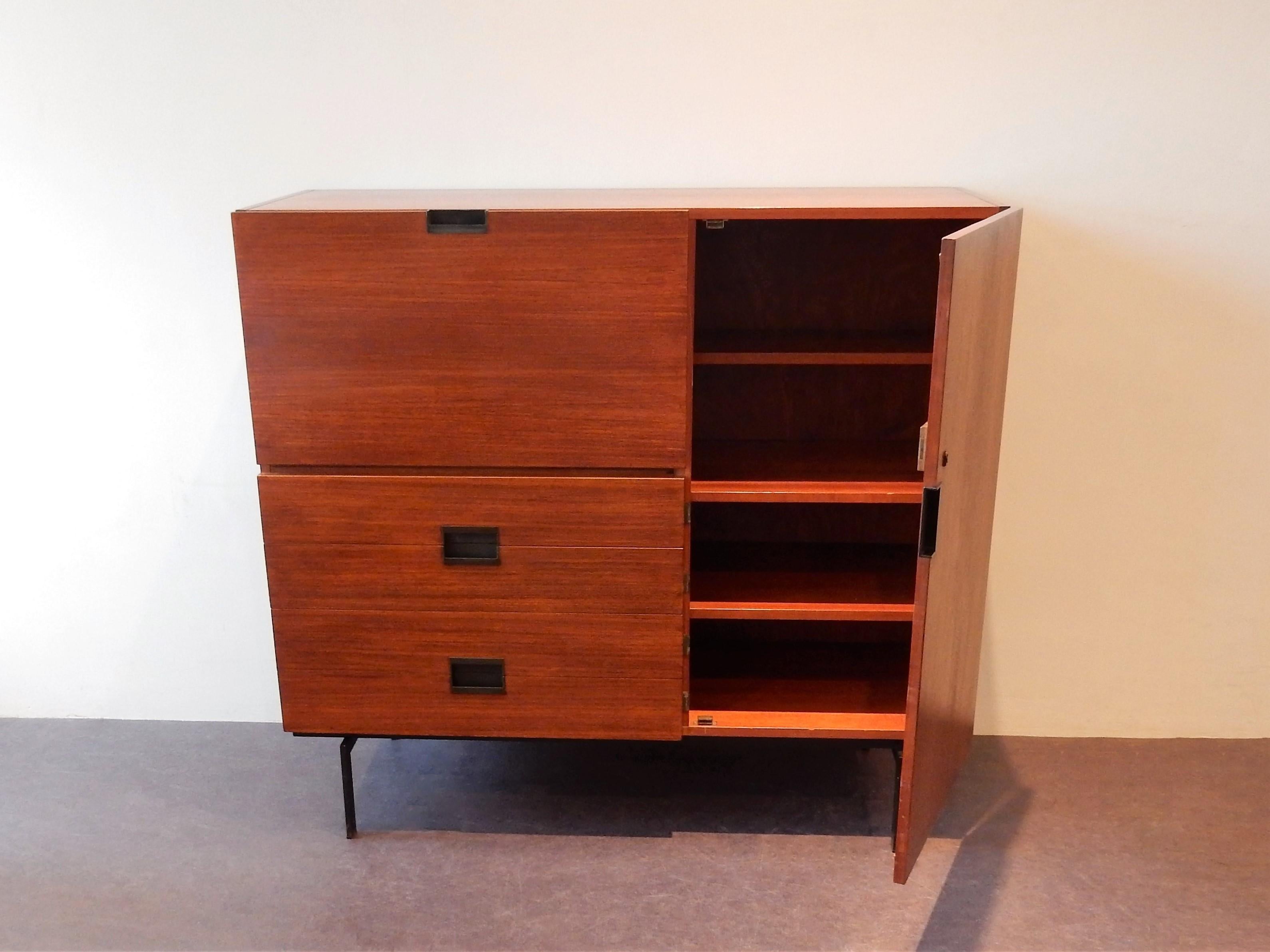 This very nice and highly collectable cabinet, from the Japanese series, was designed by Cees Braakman for Pastoe in 1958. It was originally designed as a liquor/bar cabinet. Now mostly used as storage cabinet/desk. The cabinet is made from teak