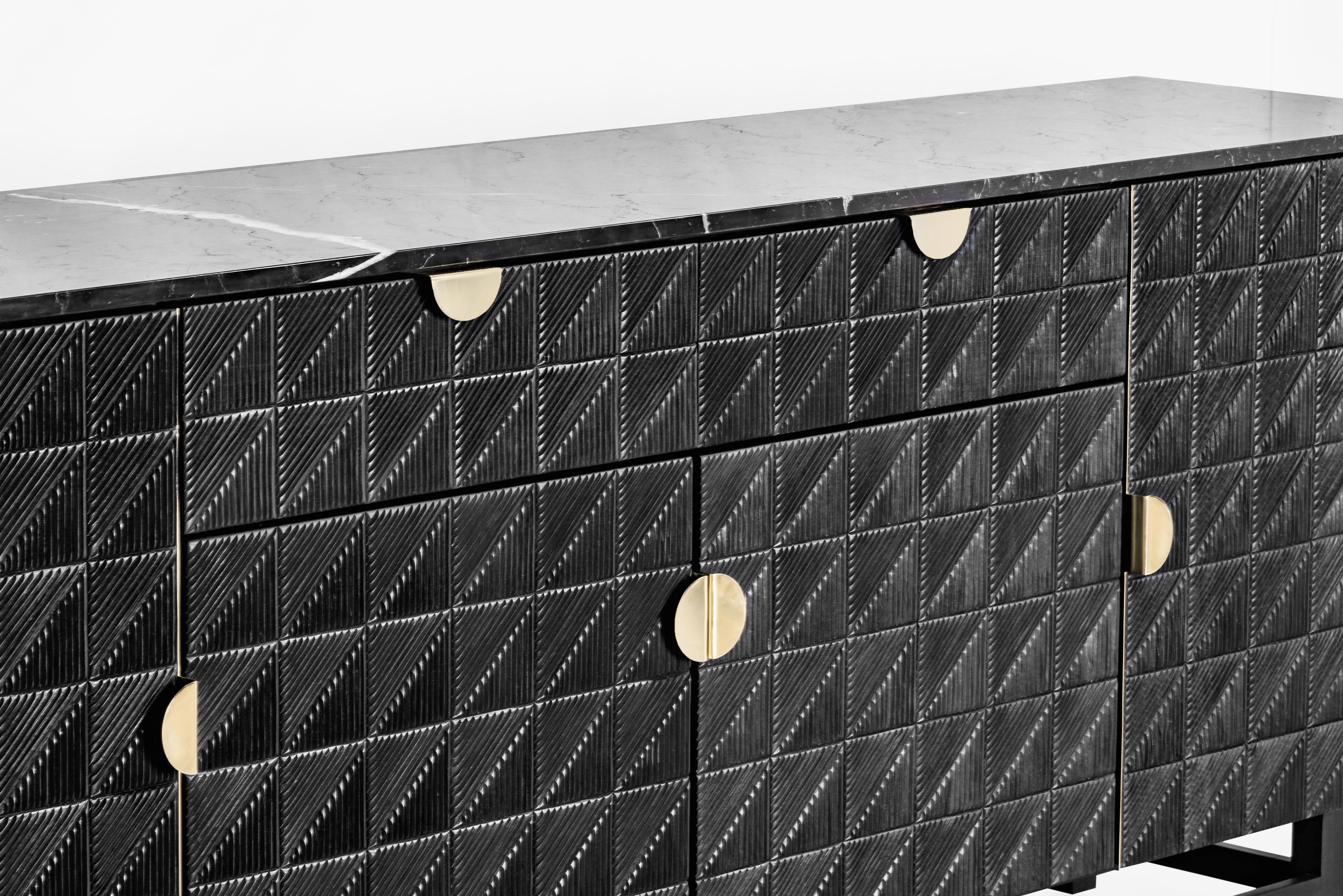 This credenza is a piece to touch, the ideal accent for a space with a lot of personality. Its fronts carved by hand in solid cedar wood with a black finish, generate a sensory experience with its impressive reliefs made with master craftsmanship.