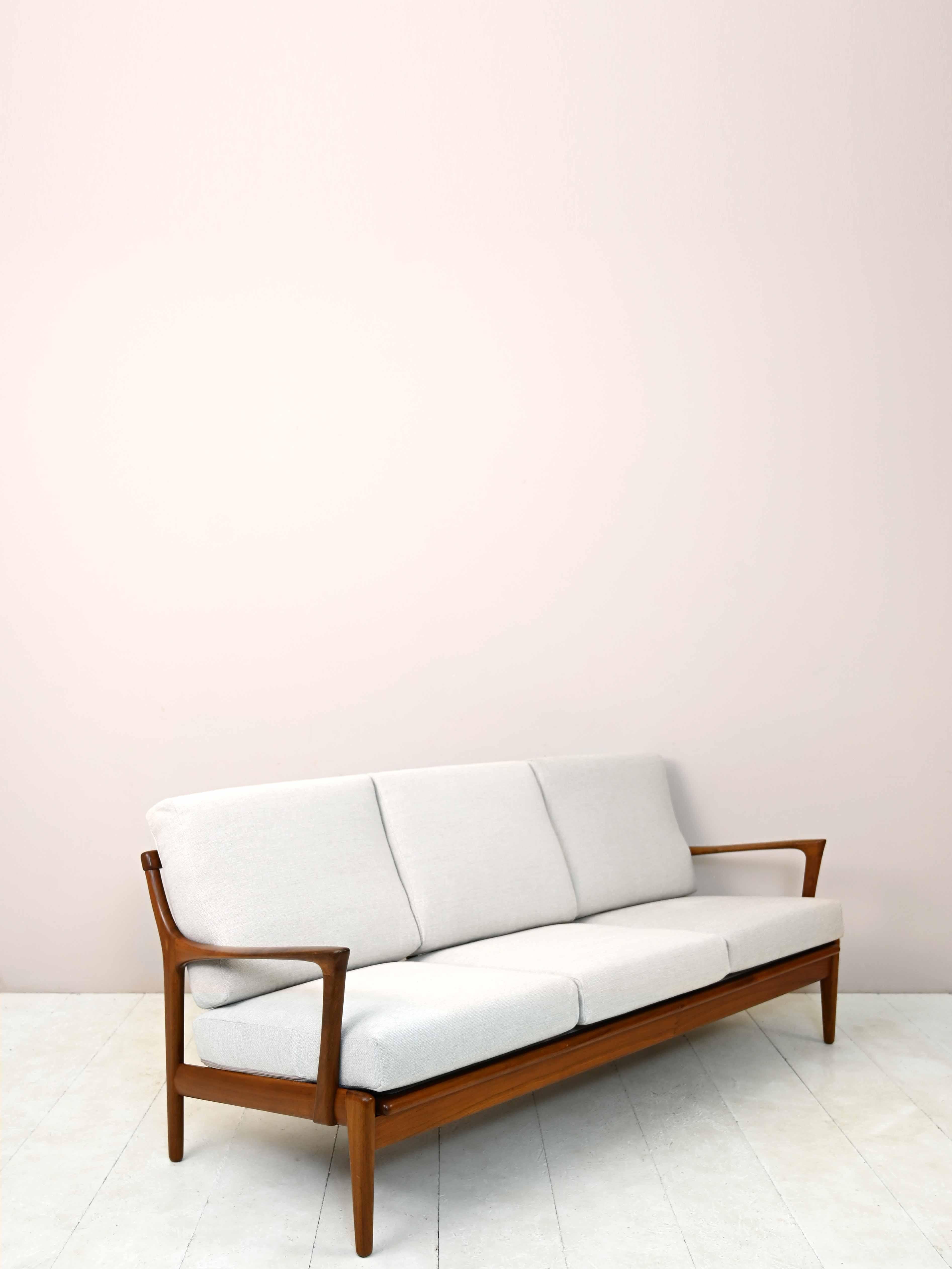 Vintage Scandinavian 3-seater sofa.

Kuba model sofa designed by Bertil Fridhagen and manufactured by Bröderna Andersson in 1960s Sweden.
The frame is made of solid teak wood and features a slightly sloping back and long legs. The cushions have