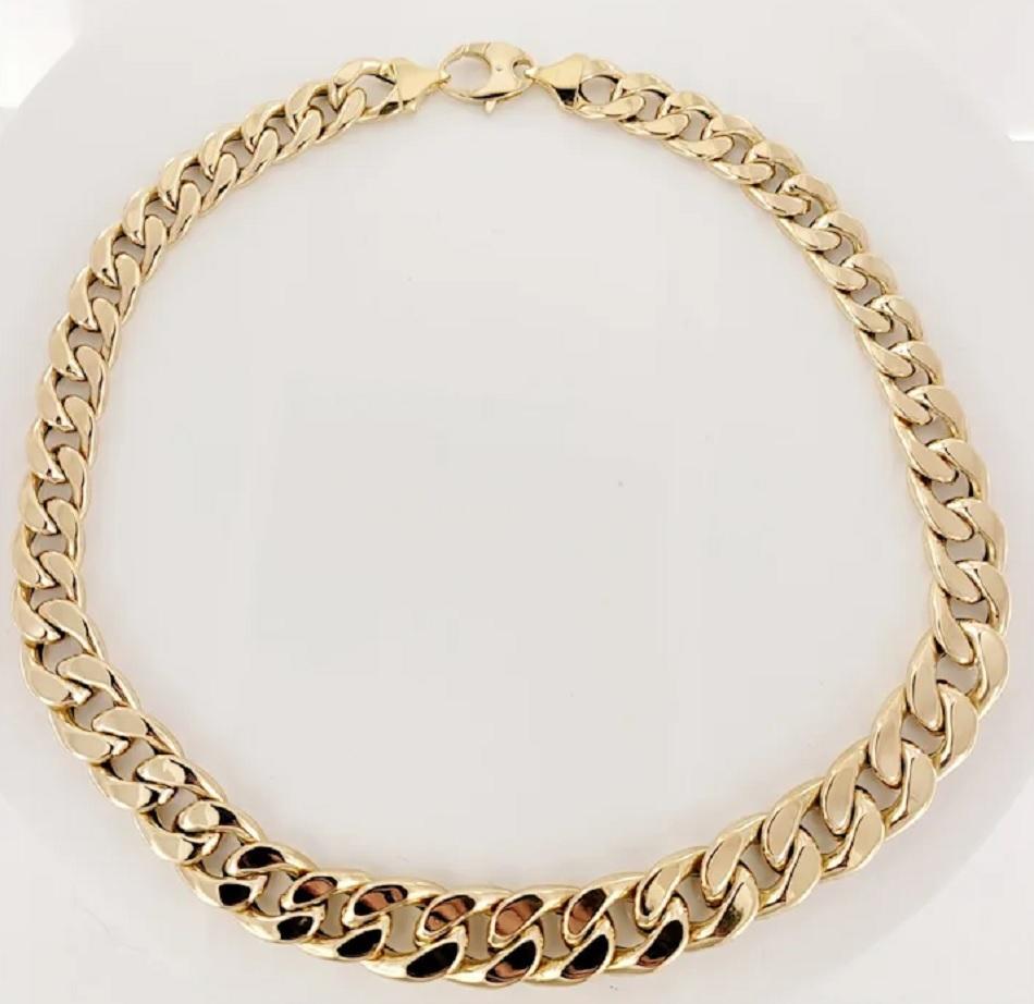 Cuban Link Chain Set in 14K Yellow Gold. Weight: 29.7 grams. Length: 18 Inches.