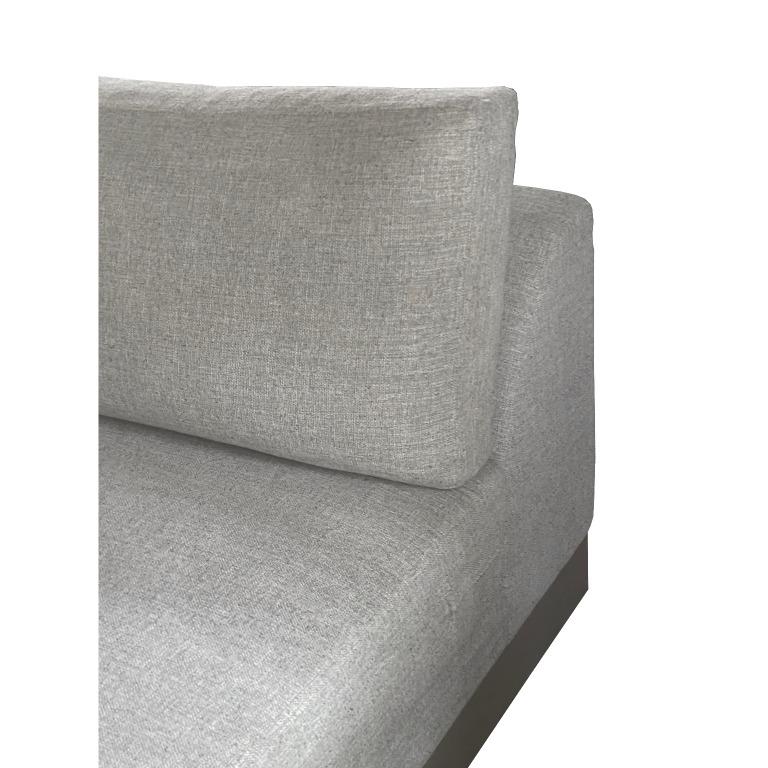 Description: a cubist hand-made sofa that exudes a sense of relaxed luxury. upholstered in a selection of soft boucle fabrics, it is designed as an essential piece to enlighten all living room settings. the low-back and deep seating design gives the