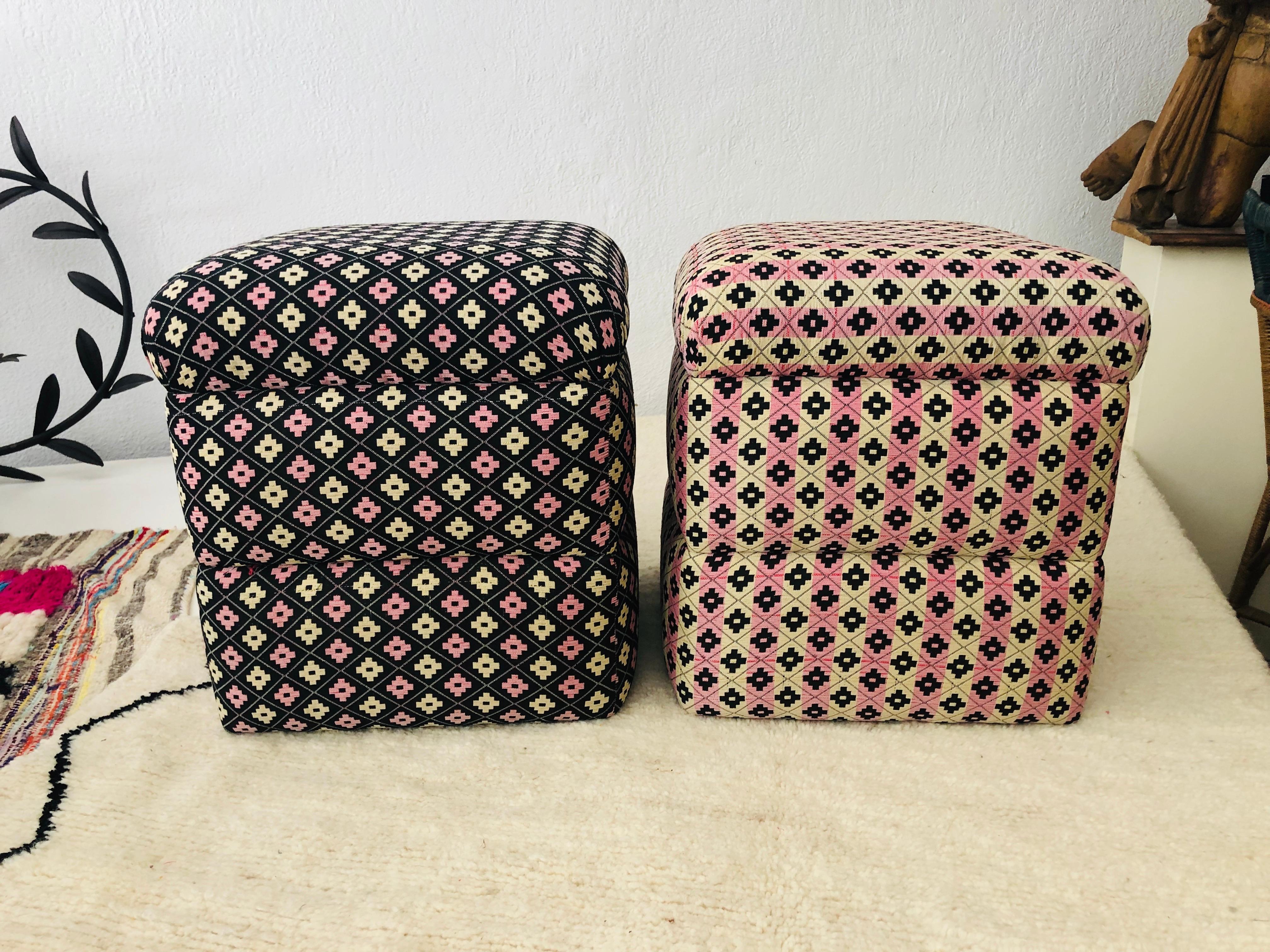Art Deco cube ottomans. The compatible pair of ottomans are recently beautifully upholstered and are hand tufted. In addition to featuring beautiful print design in black, pink and beige, the cube shape creates a bold statement in the living