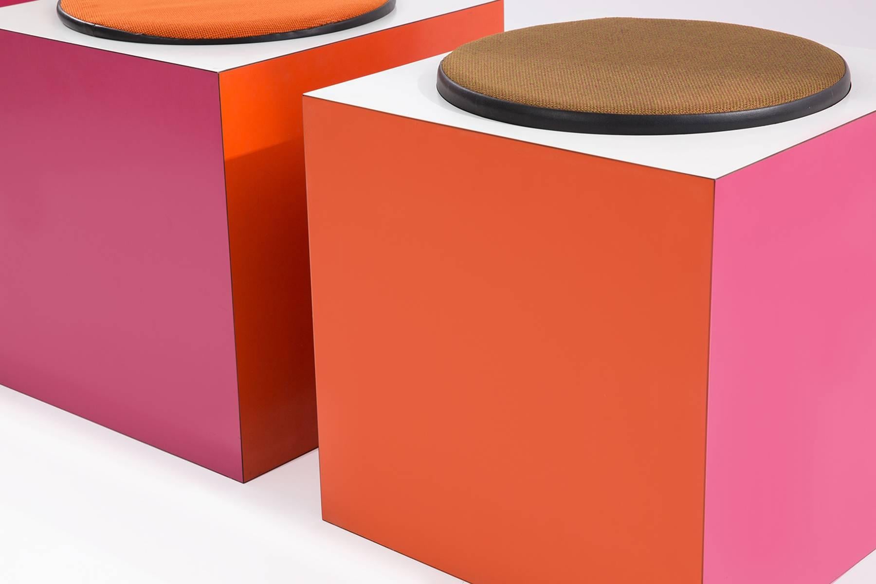 Cube ottomans custom-made for the 1967 Montreal World Expo. These fabulous examples have orange pink and white formica sides and different colored cushions. Price listed is per ottoman. Formica does have a bit of age appropriate wear.