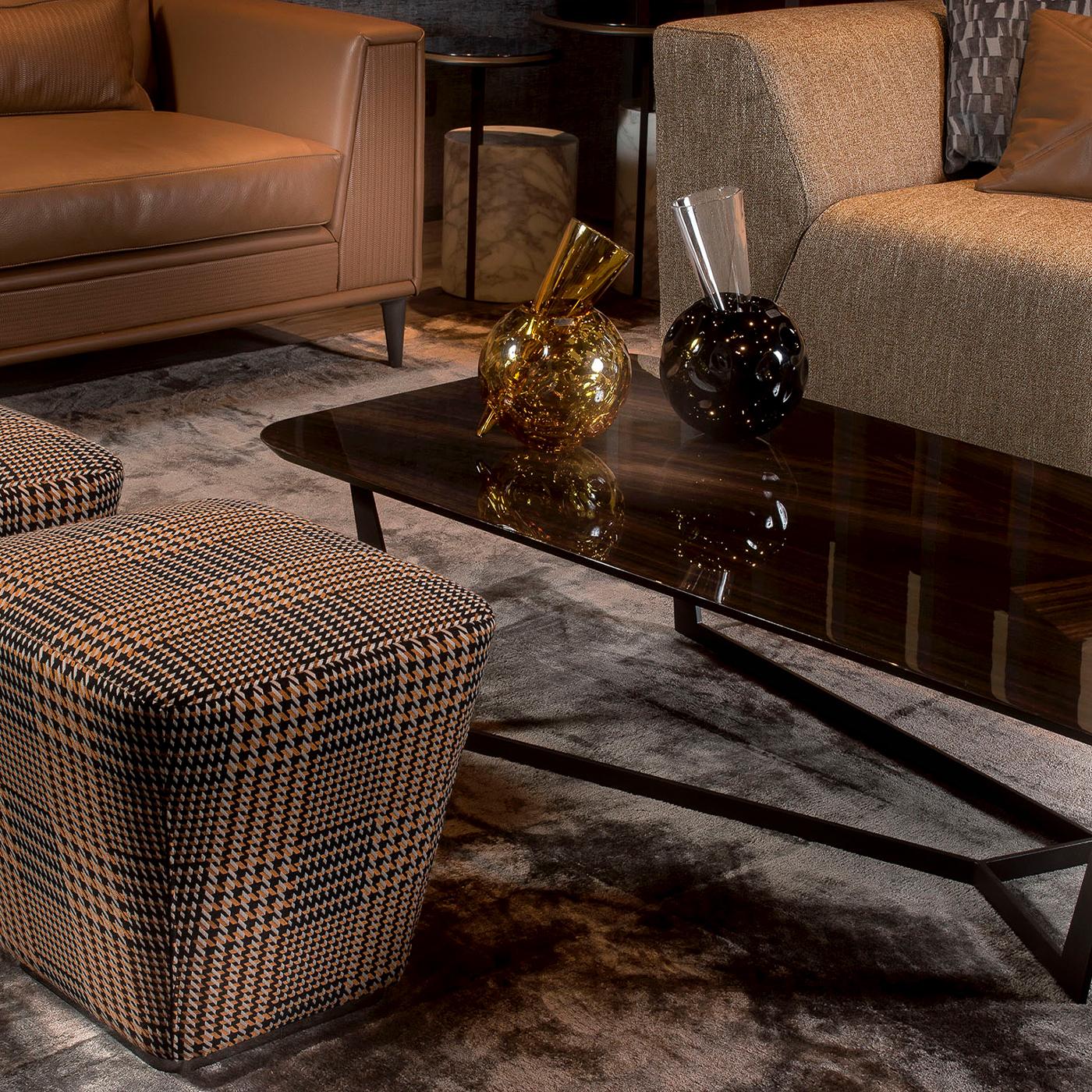 Utterly modern yet somewhat vintage-influenced, this extraordinary pouf boasts a strong and spirited character that will uniquely enrich any contemporary interior of both eclectic or minimalist style. Resting on a metal base covered with MDF, it