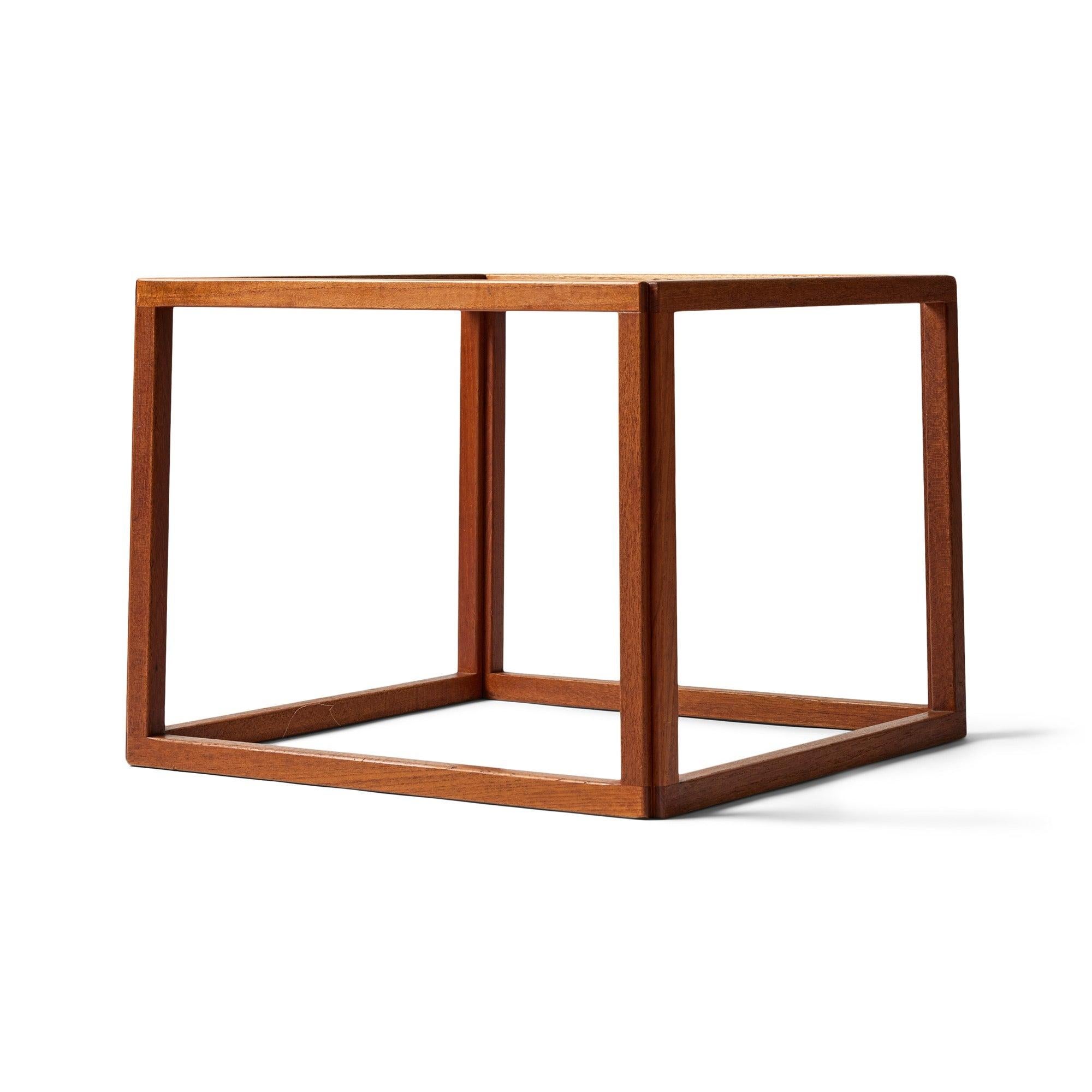 A solid teak open cube side table with a glass top.