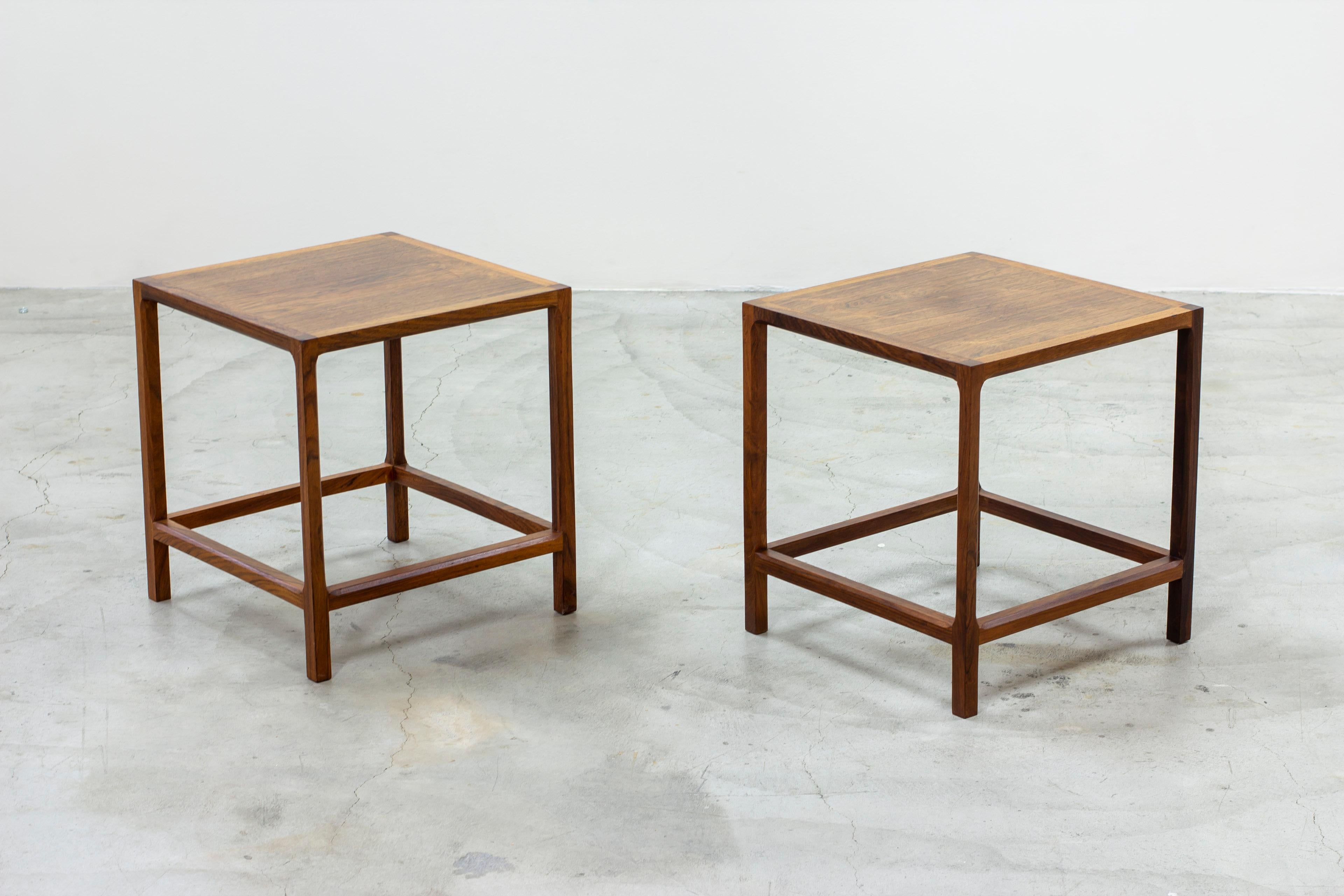 pair of side tables designed by Kai Kristiansen. Produced in Denmark by Aksel Kjaersgaard during the 1950s. Made from rosewood with nice grain. Beautifully detailed with angled corners. Good vintage condition with age related wear and patina from
