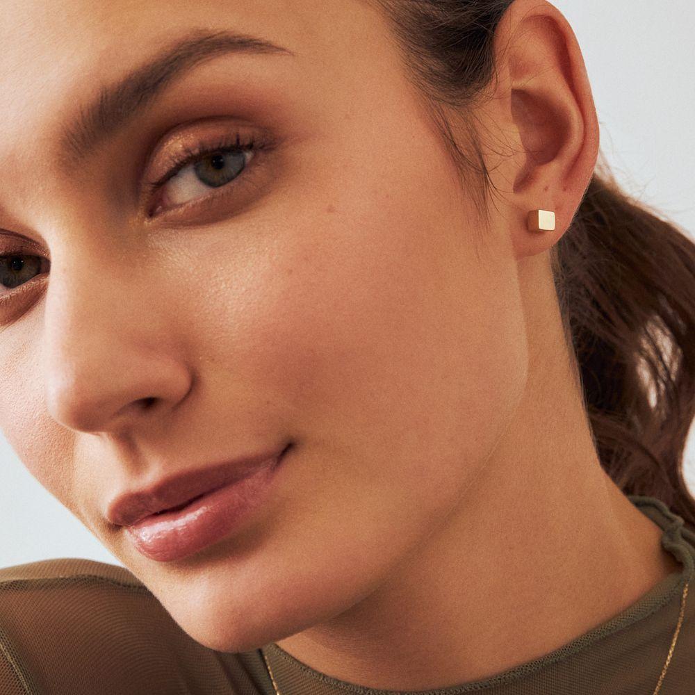 Introducing the 14K Solid Gold Cube Earrings, an embodiment of Orena Jewelry's commitment to timeless design and unmatched artistry. Hand-forged with precision, each earring epitomizes the beauty of minimalistic luxury, making it an impeccable