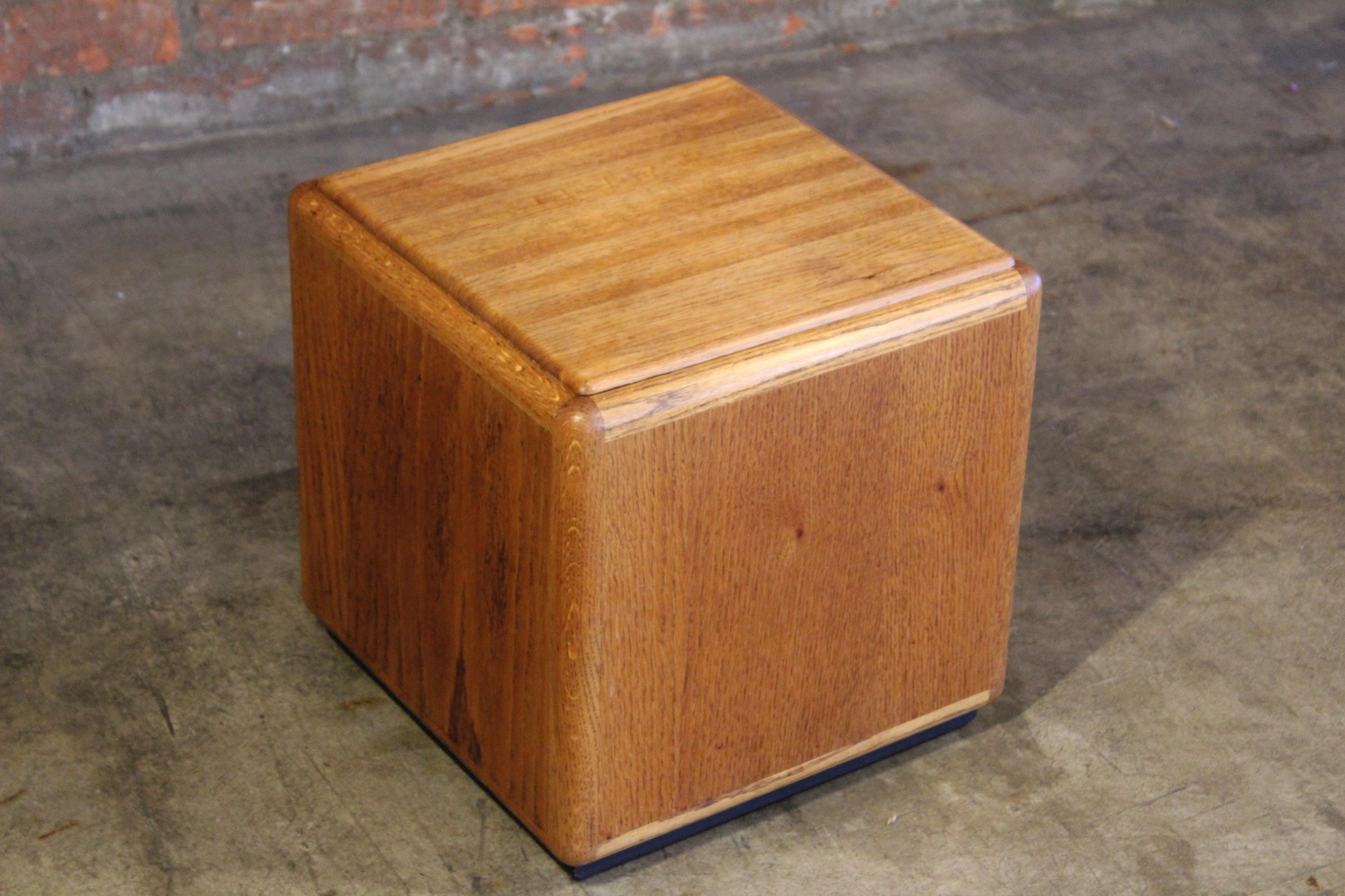 A vintage oak storage cube that doubles as a side table. Designed by Lou Hodges in California, 1970s. 