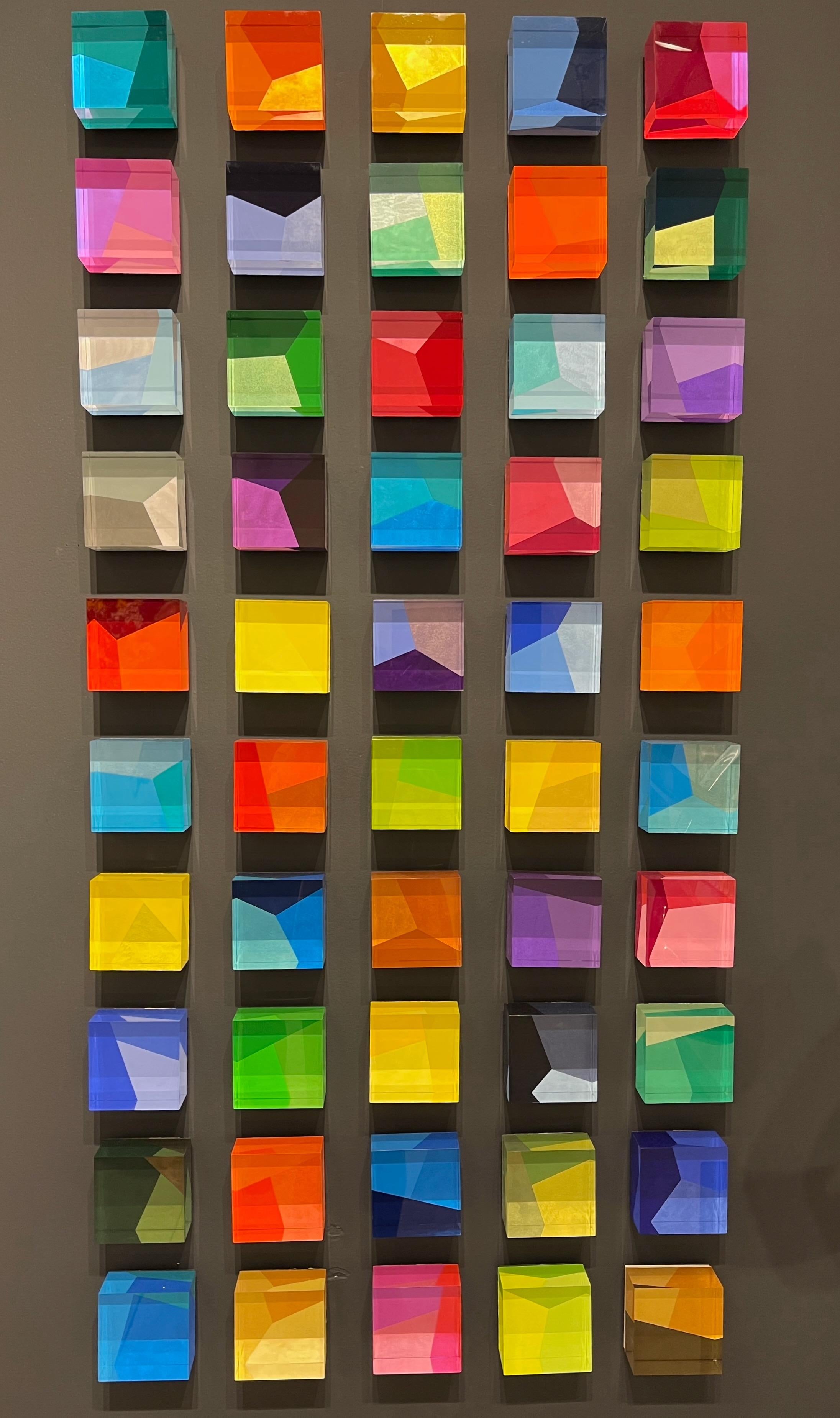 The cubes are solid acrylic which have been painted in reverse on the back of each cube, they have hardware installed on the back so that they can be easily hung on the wall. The cubes are 2 inches thick, and are 4 X 4 inches square.