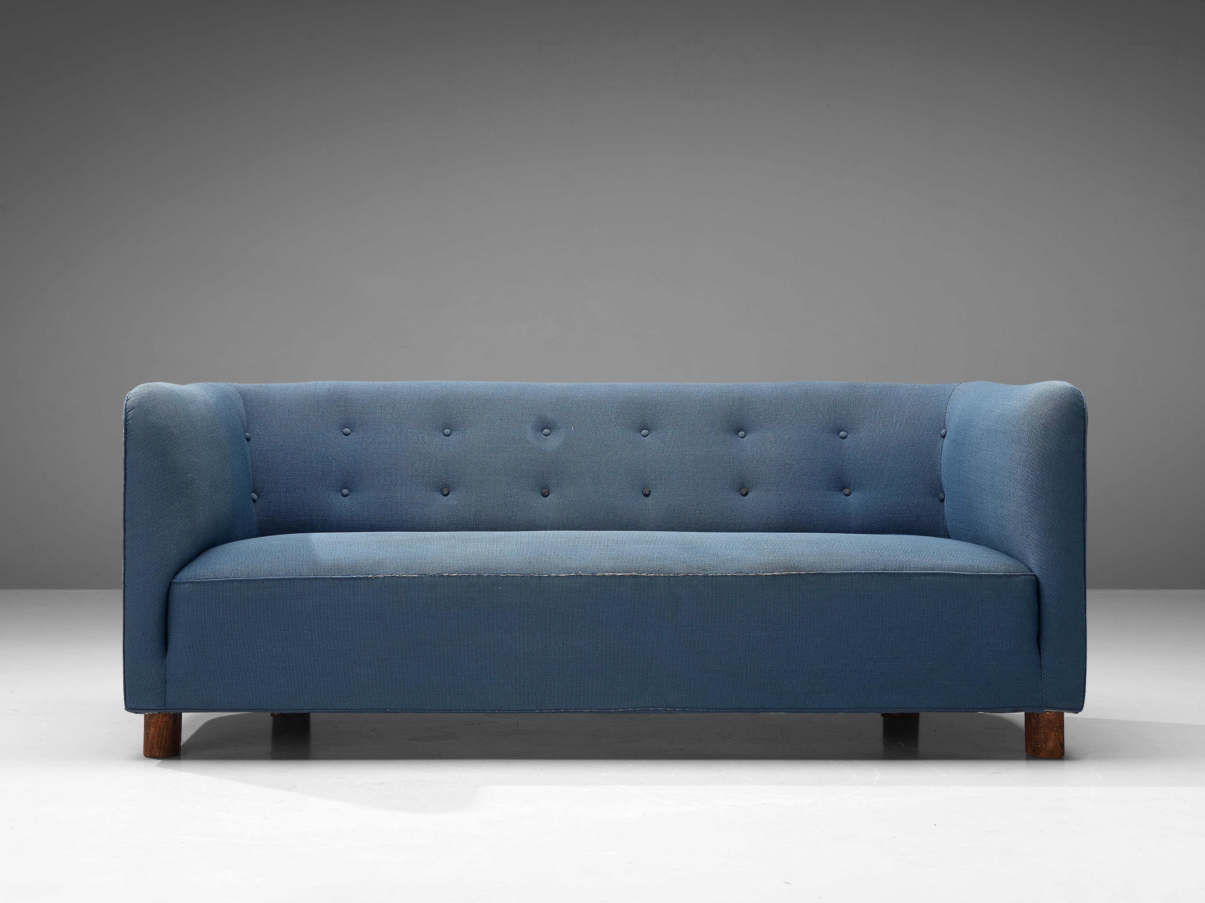Danish sofa, upholstery, wood, Denmark, 1960s

Cubic Danish sofa in blue upholstery. The low backrest flows into the armrests on the same height. The backrest features tufted details. Please note that the back of the sofa is not finished with the