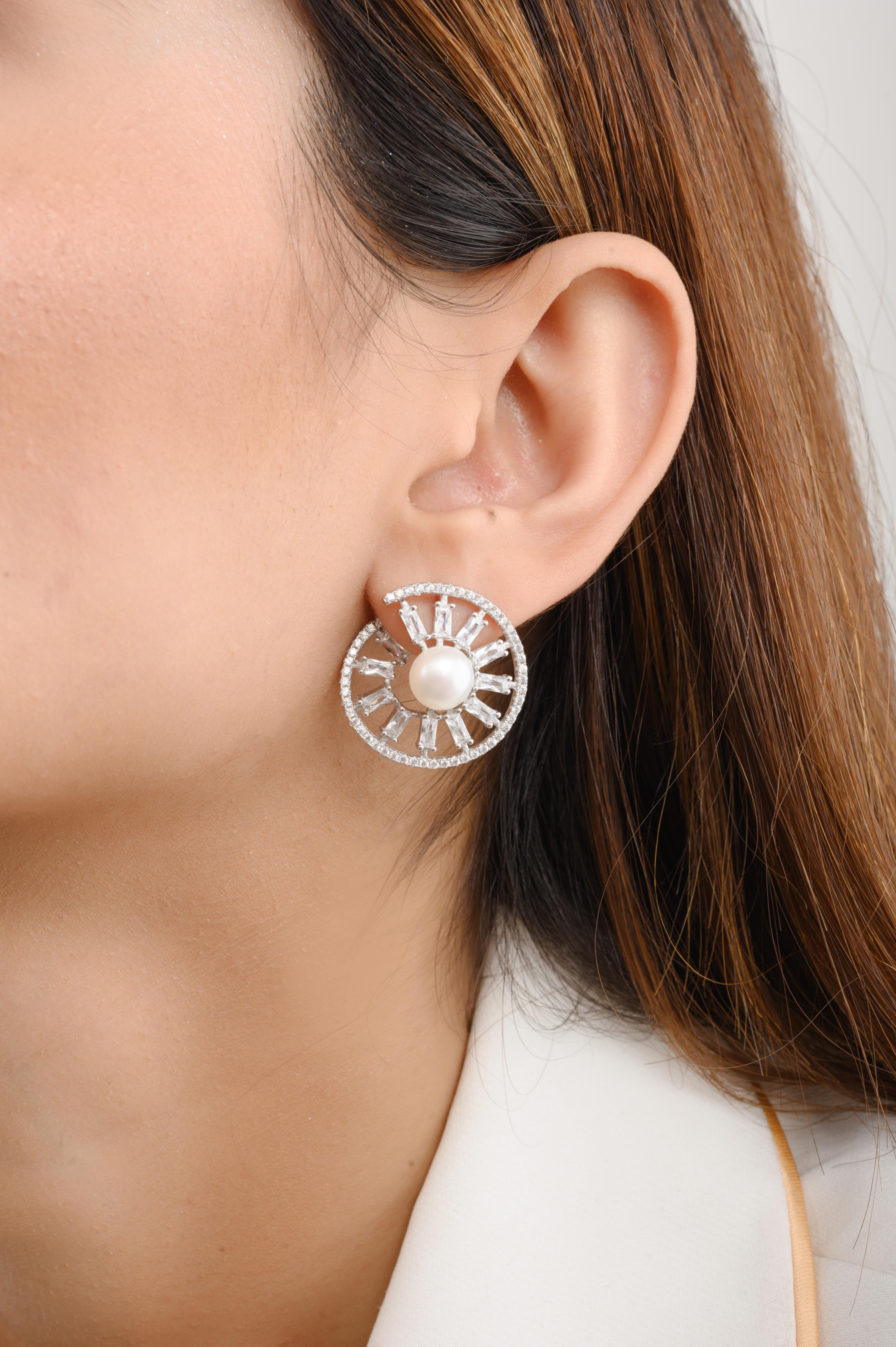 Cubic Zirconia Pearl Wheel of Fortune Stud Earrings in sterling silver. You shall need these stud earrings to make a statement with your look. Each piece features dazzling cubic zirconia stones, renowned for their brilliance and clarity, set in