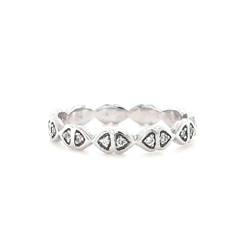 Experience the enchantment of love with our Lily of the Valley wedding band. Crafted in sterling silver, this exquisite piece showcases a series of bow-motifs, set with an array of sparkling cubic zirconia. With its graceful design and timeless