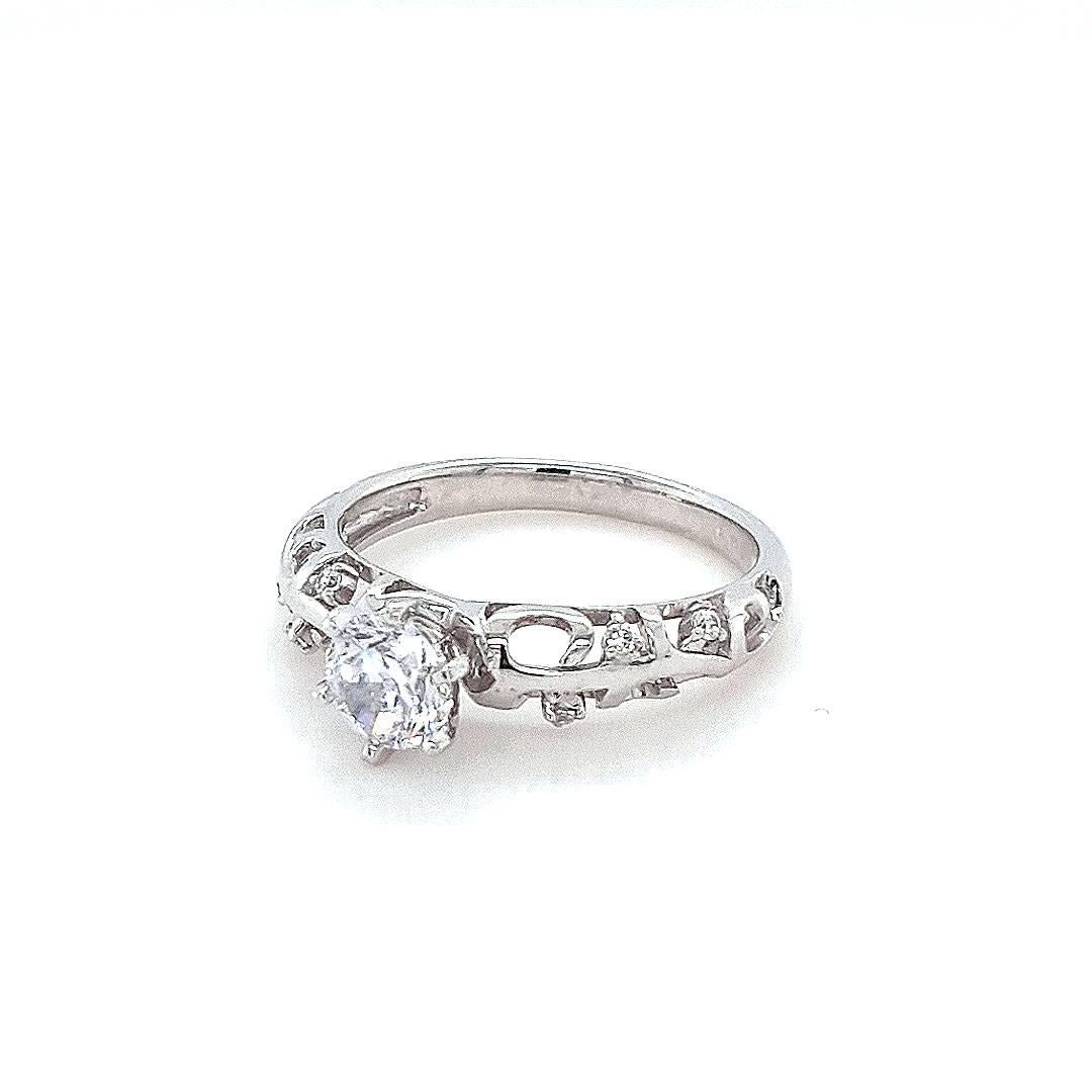 Introducing the epitome of elegance and romance, behold the Spring Willow 0.5ct Engagement Ring. This exquisite piece showcases a sterling silver band adorned with sparkles of cubic zirconia intricately woven between wispy forms of precious metal.