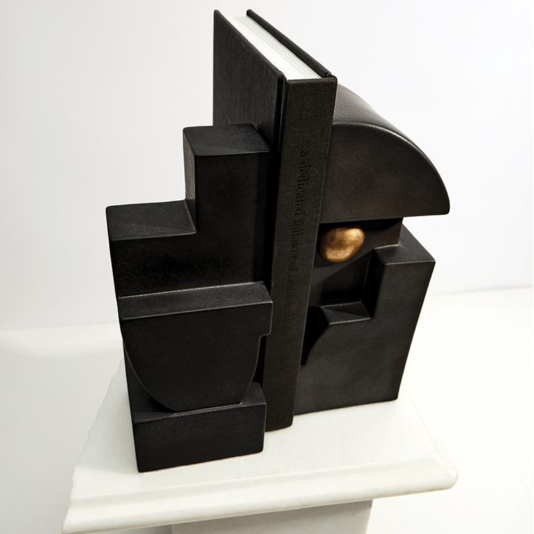 With a nod to both cubist art and Mayan carving, Cubisme takes geometric simplicity to a new level. Bookends are created from lightly textured earthenware and feature antiqued gold accents. Sold separately, Cubisme Bookend 1 and Cubisme Bookend 2