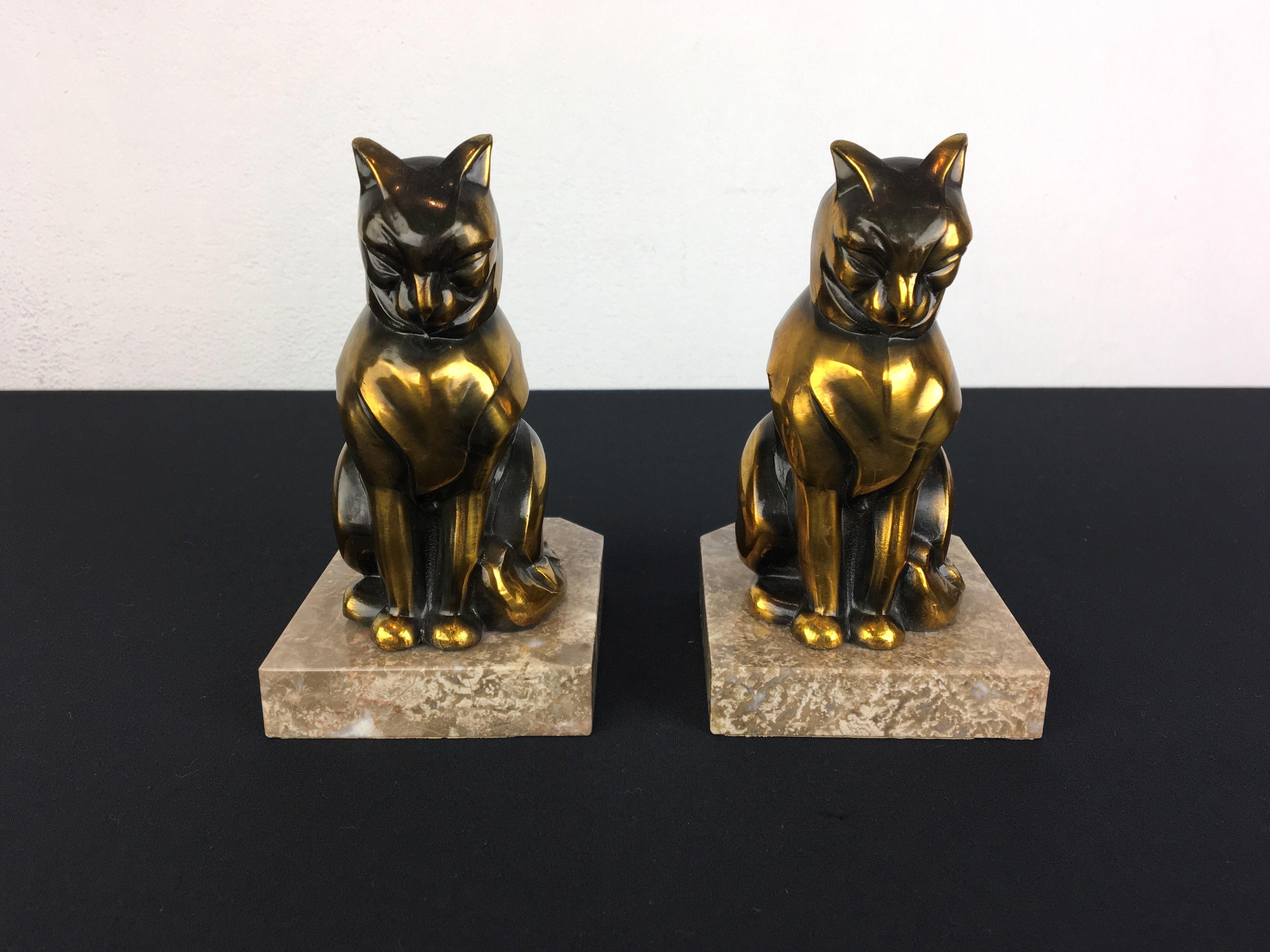 Cubist Art Deco Bookends with Cats. 
These animal bookends have gold patinated metal – spelter cats mounted on marble bases. 
Both bookends with cat sculptures are signed by Franjou, also known als Hippolyte Moreau. 
These cat bookends are still in