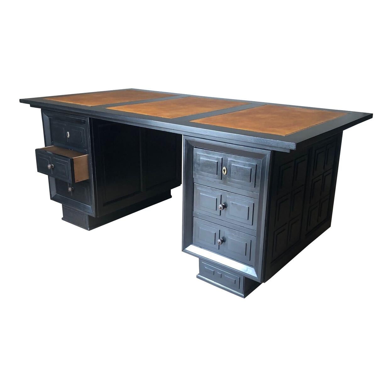 1940s French ebonized cubist design wood desk with leather top in the style of Maxime Old
Light brown leather top with Greek key border
Six drawers.
  