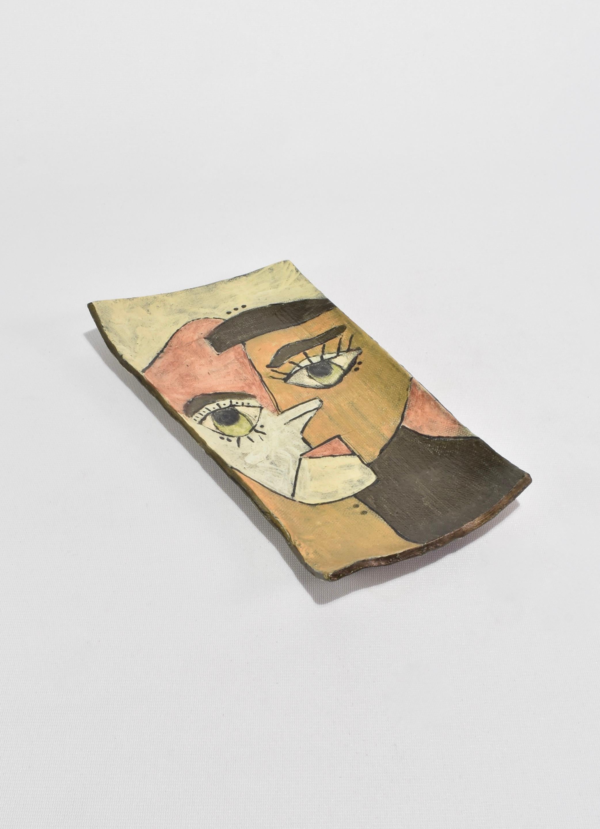 Mid-century handmade ceramic tray with cubist face detail. ﻿Signed on base.