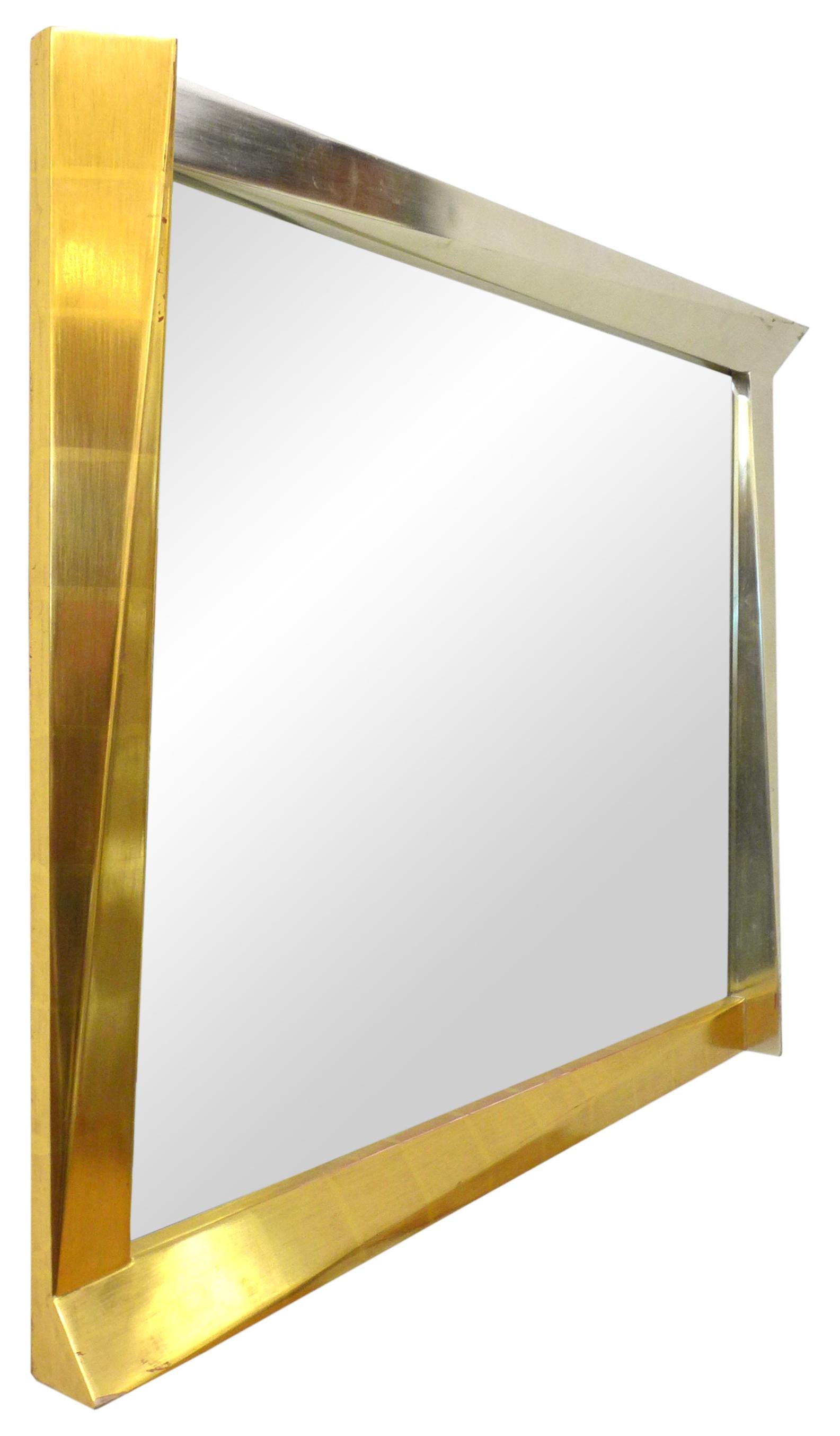 A fantastic, cubist, giltwood-framed mirror. A wonderful, optically-alluring geometric frame playfully jutting out of its expected space at various angles; adding to the illusion, a subtle gold gradient change diagonally across its entirety. Chic