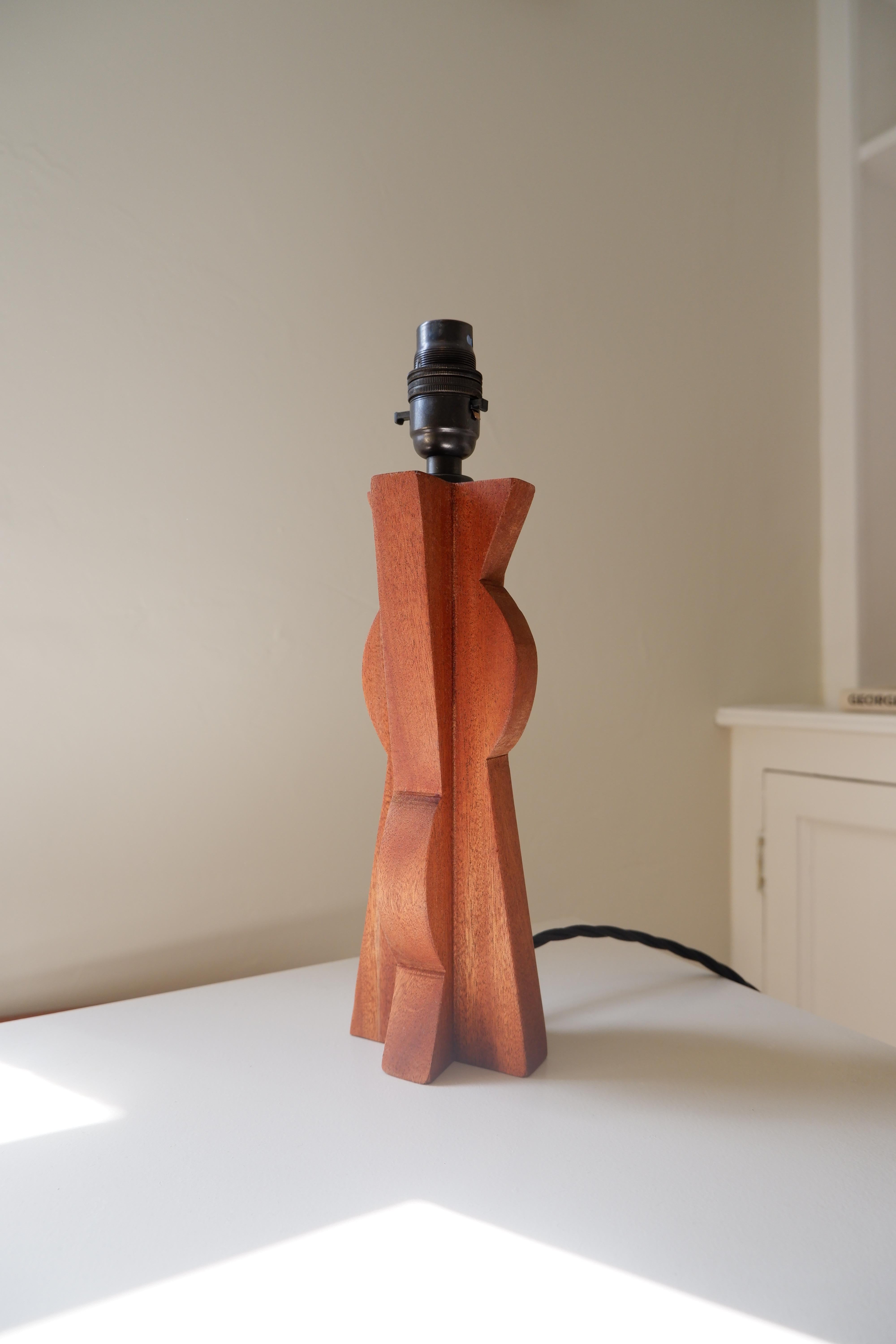 Sapele Table lamp with bronze lampholder and black twist cable in cubist style.

An Abstract piece that can sit playfully alongside the Kent Table Lamp.

Please note that due to the handmade nature, each piece may vary.  Lamp shade not included.