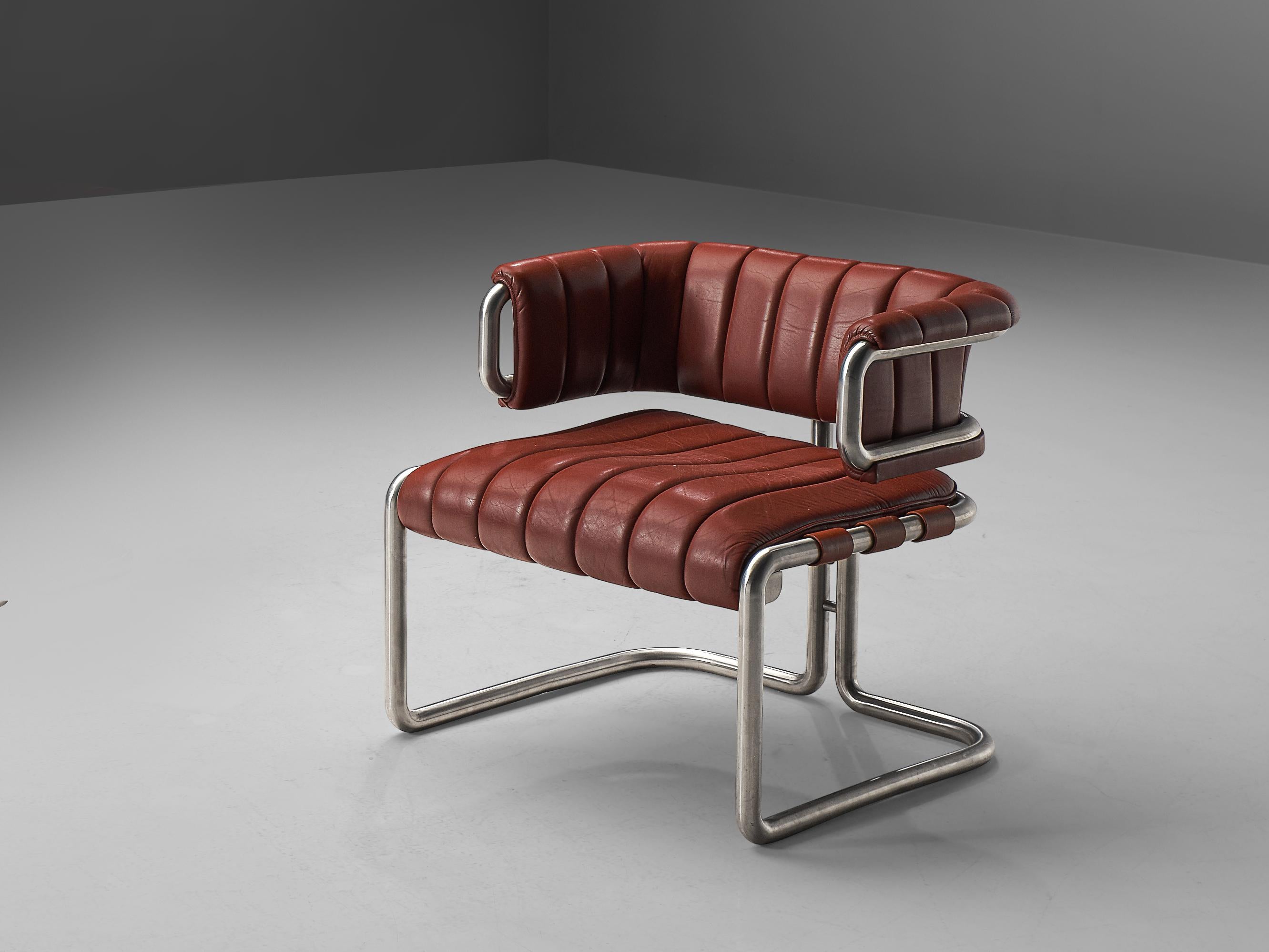 Lounge chair, red leather, tubular steel, Germany, 1960s

This chair is characterized by clear, straight lines that are noticeable in the leather as well. The tubular frame is made out of stainless steel and shows beautiful forms. In the back two