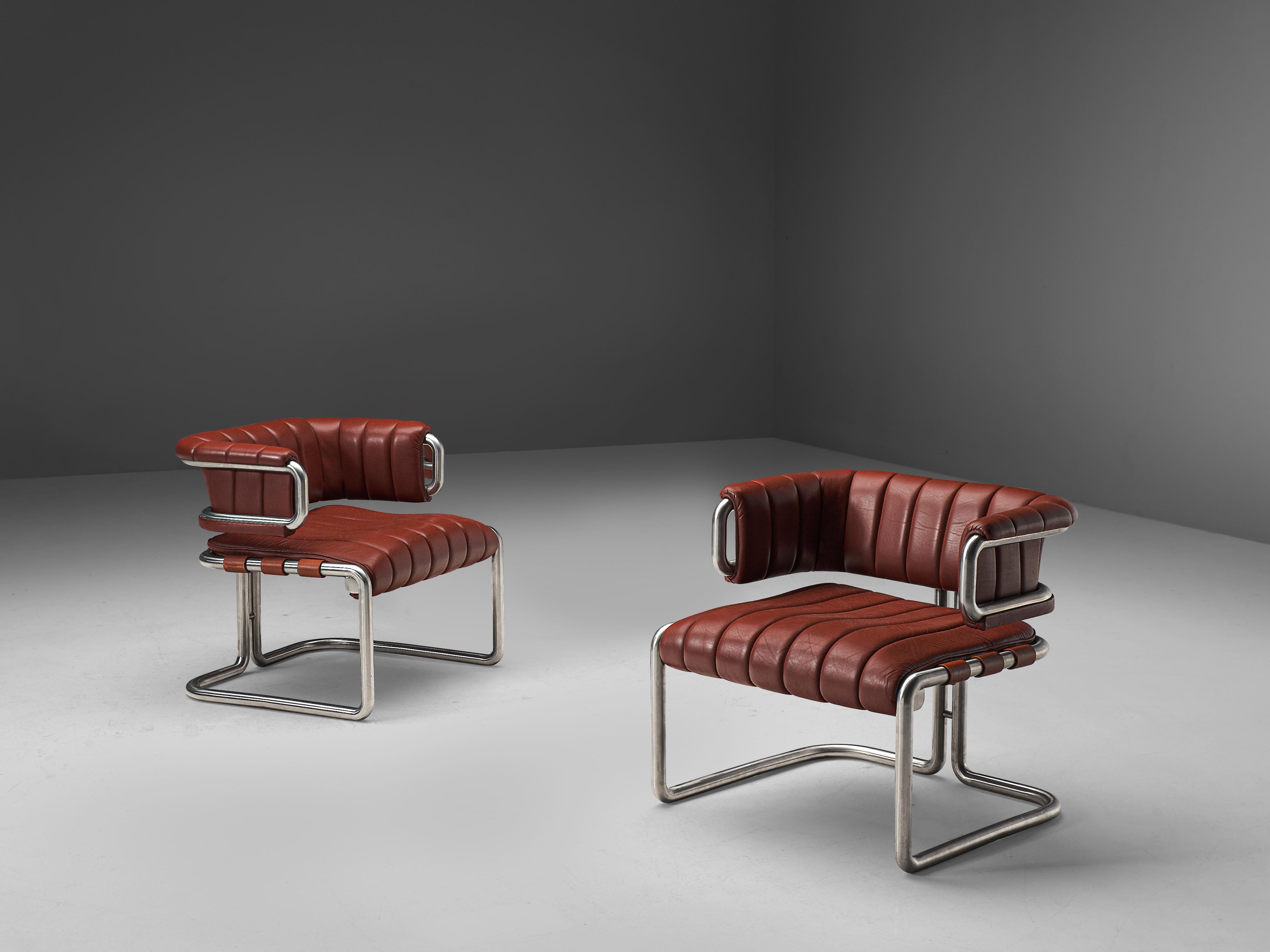 Lounge chairs, red leather, tubular steel, Germany, 1960s

This set is characterized by clear, straight lines that are noticeable in the leather as well. The tubular frame is made out of stainless steel and shows beautiful forms. In the back two