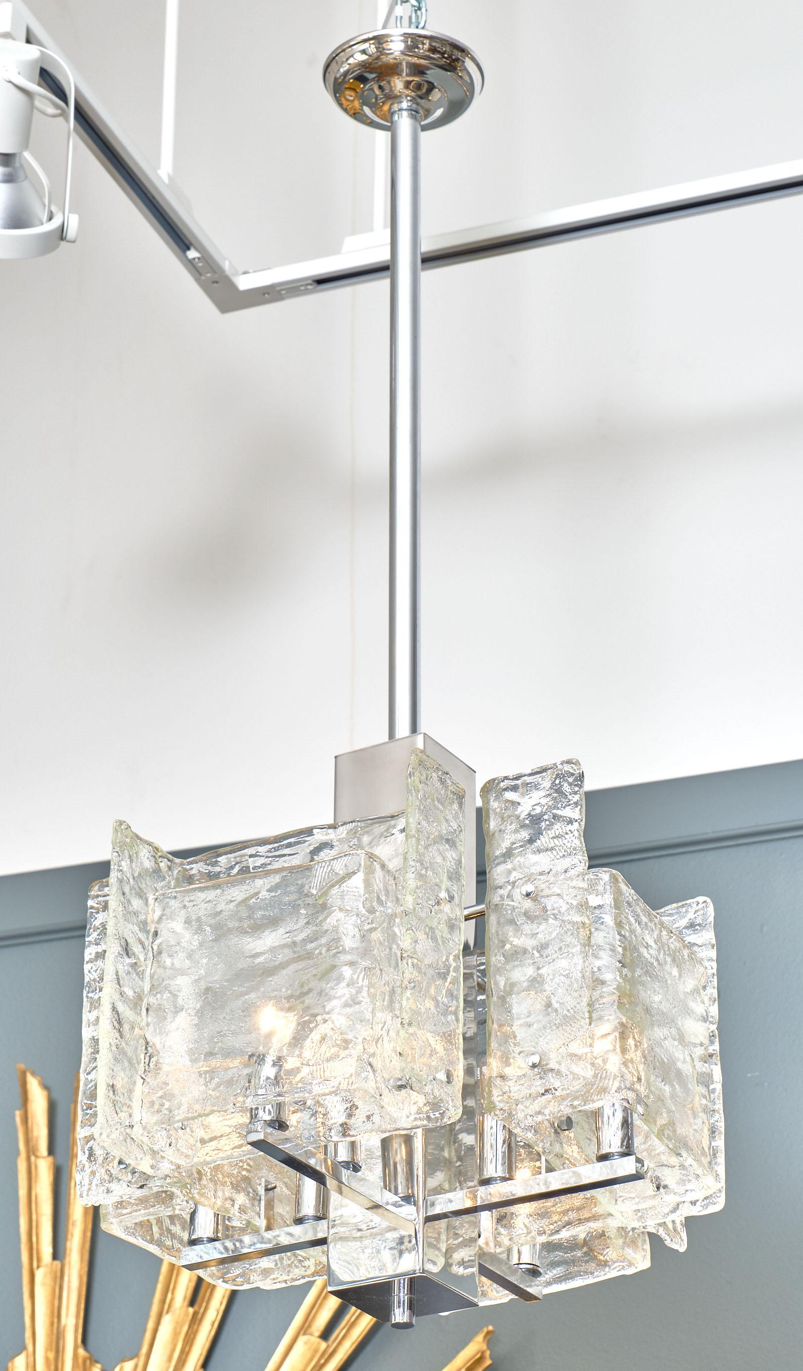 Italian Murano glass cubist chandelier by Mazzega. We love the textured hand blown glass and the chrome structure. This piece has been newly wired to fit US standards.