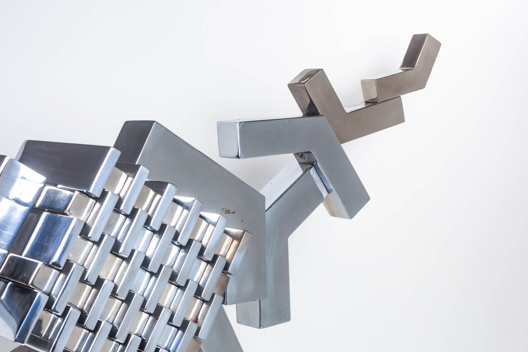Cubist Sculpture in Mirror Polished Chrome
Striking Cubist-style mirror in polished chrome on plinth base. This sculptural piece features a dynamic interplay of angles and reflective surfaces, offering a sleek, modernist presence.
Provenance:
Ziuta