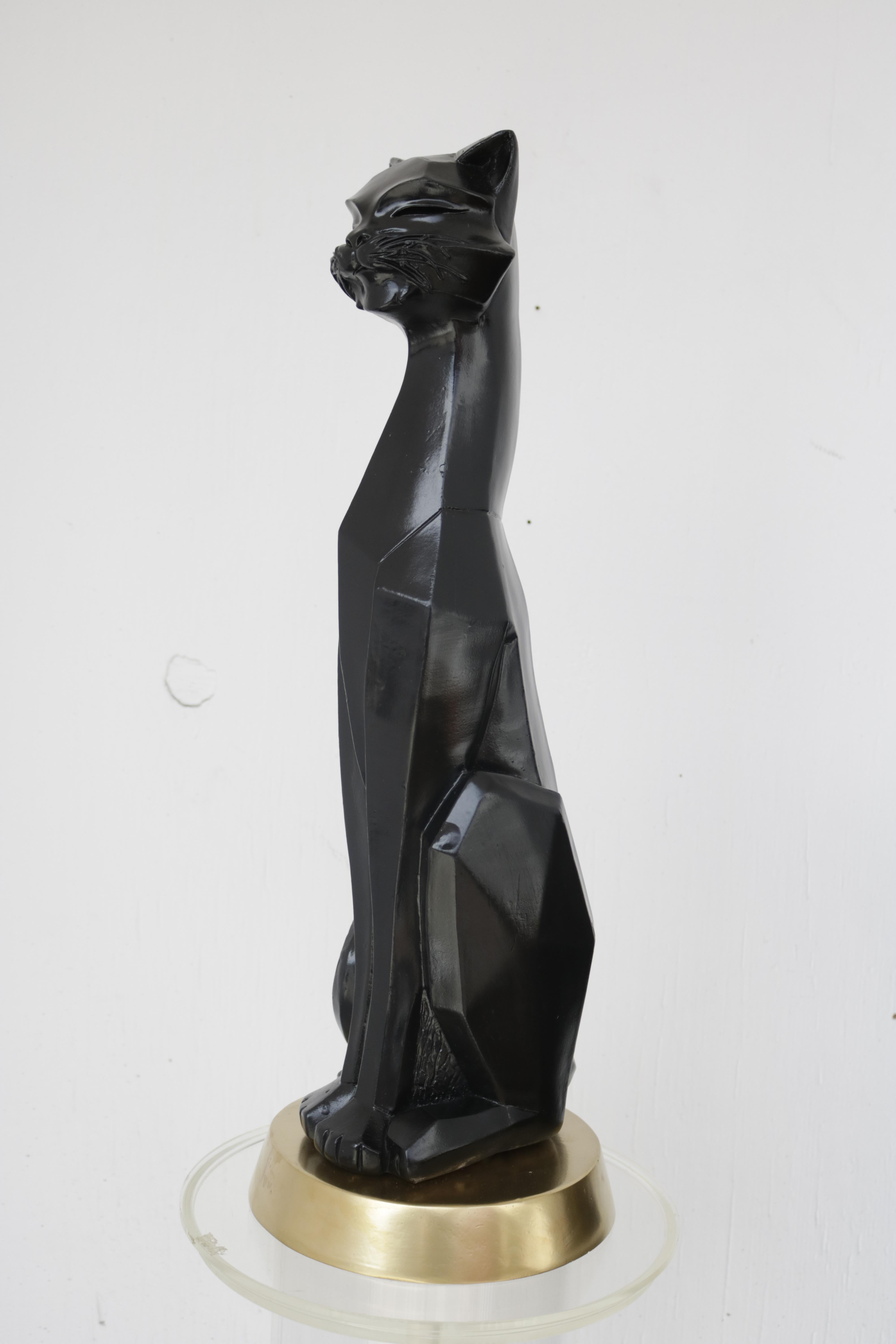 Modern Cubist-style plaster sculpture of a black Siamese cat on a gold base. From the 1960s and signed Universal Statuary Corp. The company was a Chicago based manufacturer founded in the 1930s that made chalk and plaster sculptures in whimsical