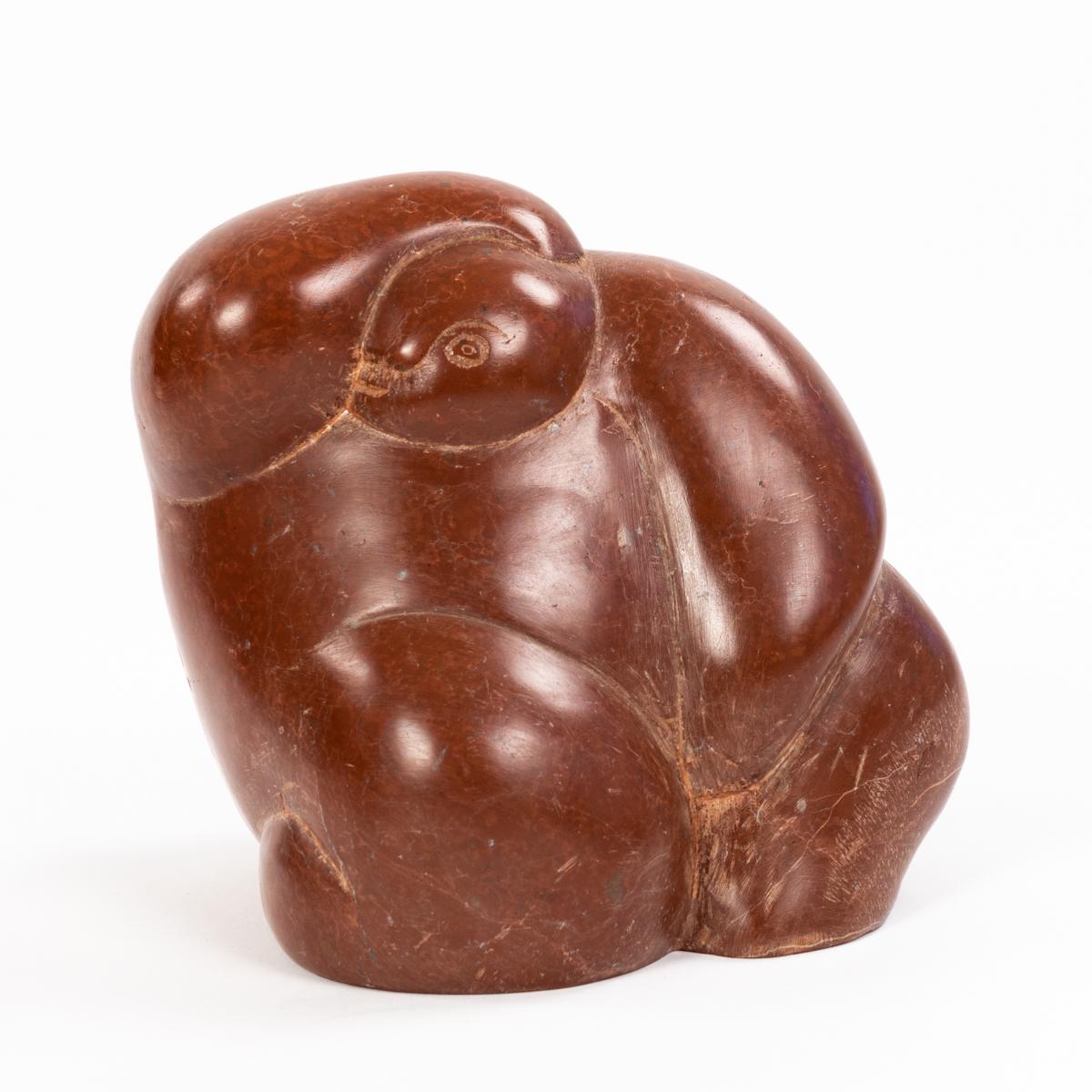 Cubist figurative French mid-century sculpture in brown-red stone, signed.
The round shaped object shows a figure like a sketch with one arm above the head and the other between the legs.
The object is organically round and thus has a soft, almost