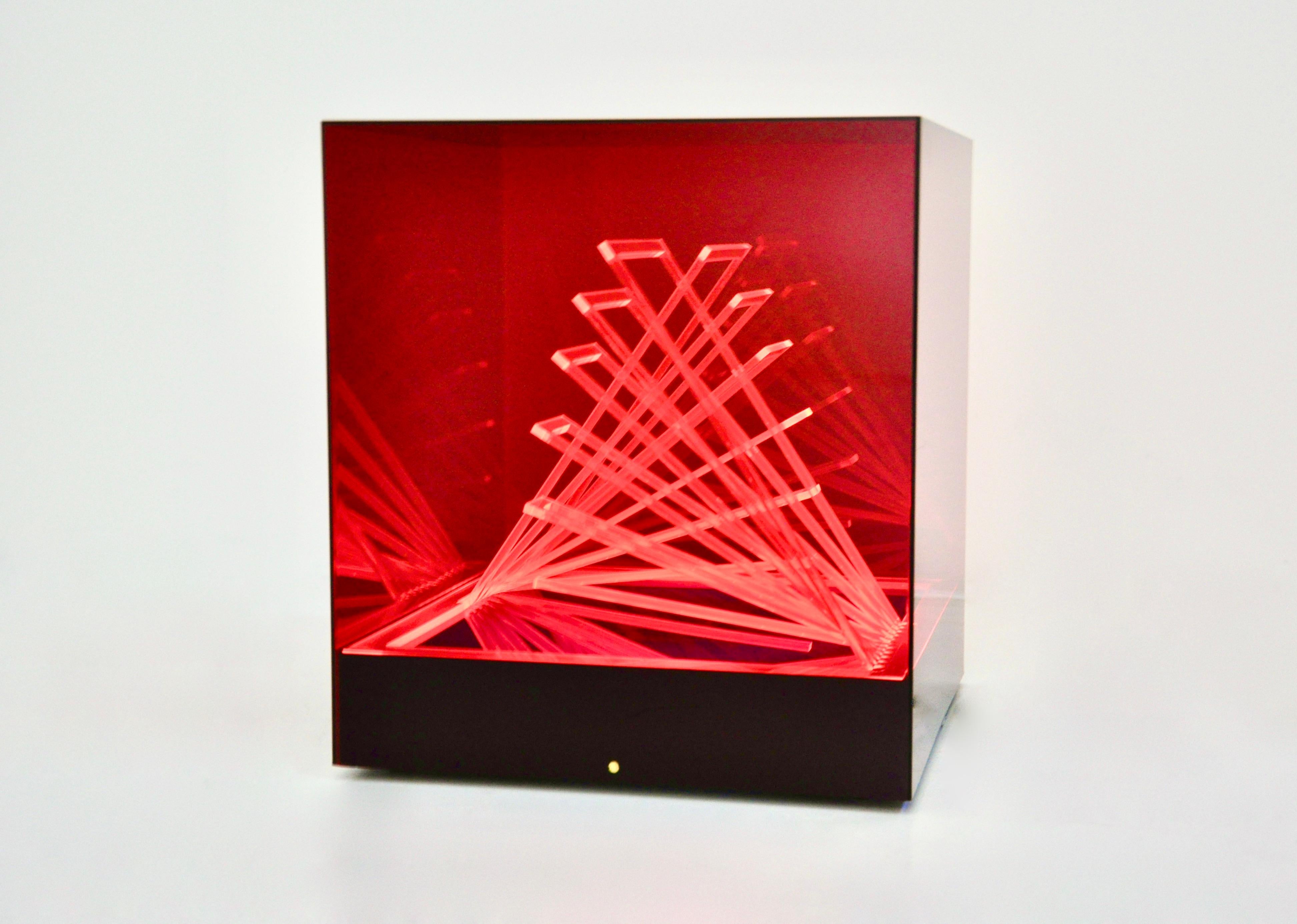 Red plastic lamp with neon inside by James Rivière. Made in Italy in the 60s. Model: Cubo di Teo.  