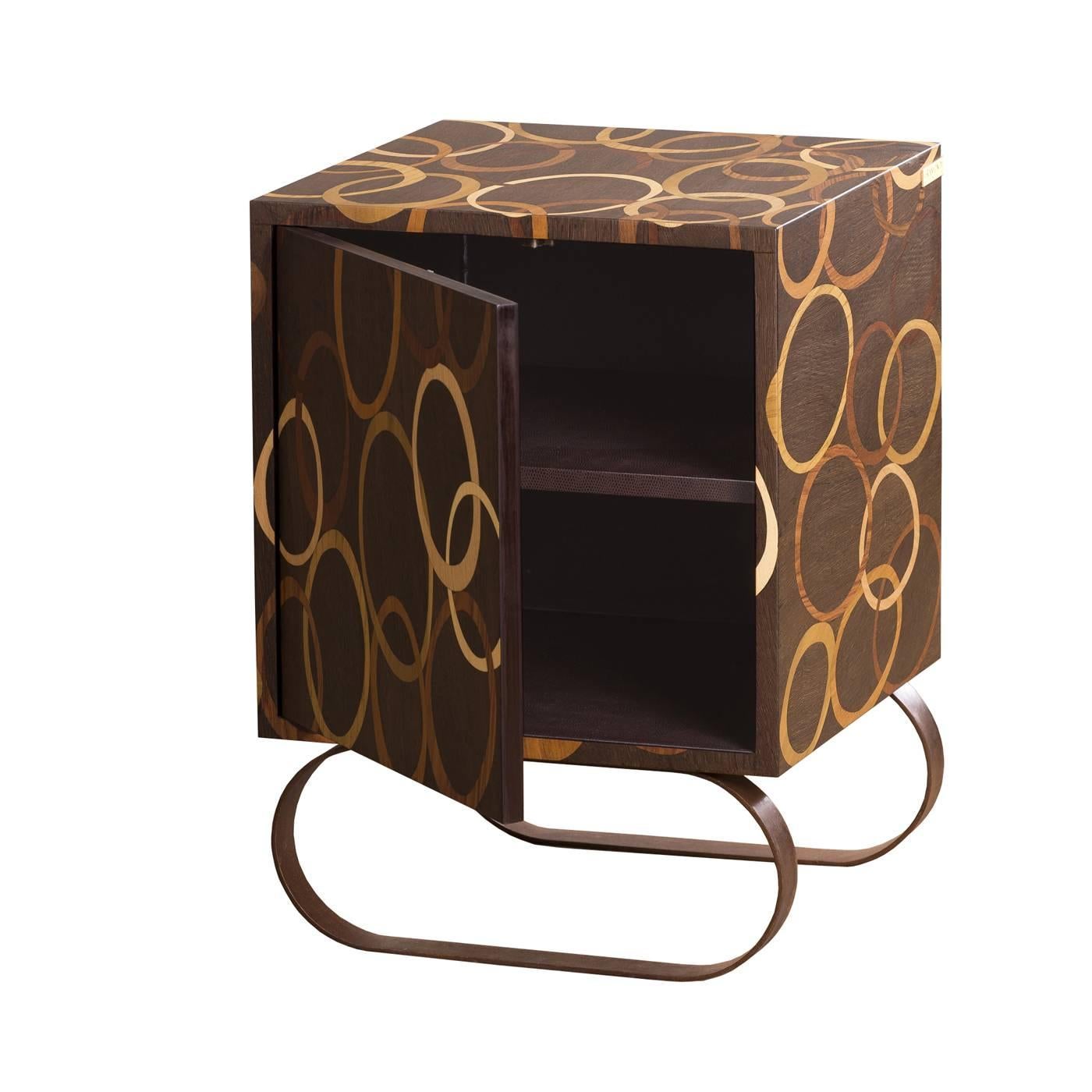 This bedside table has one door which opens up to reveal a single interior shelf. The multi-layer poplar structure serves as the base for the exquisite hand-made pattern on the exterior, achieved using an ancient inlaid wood technique. The woods