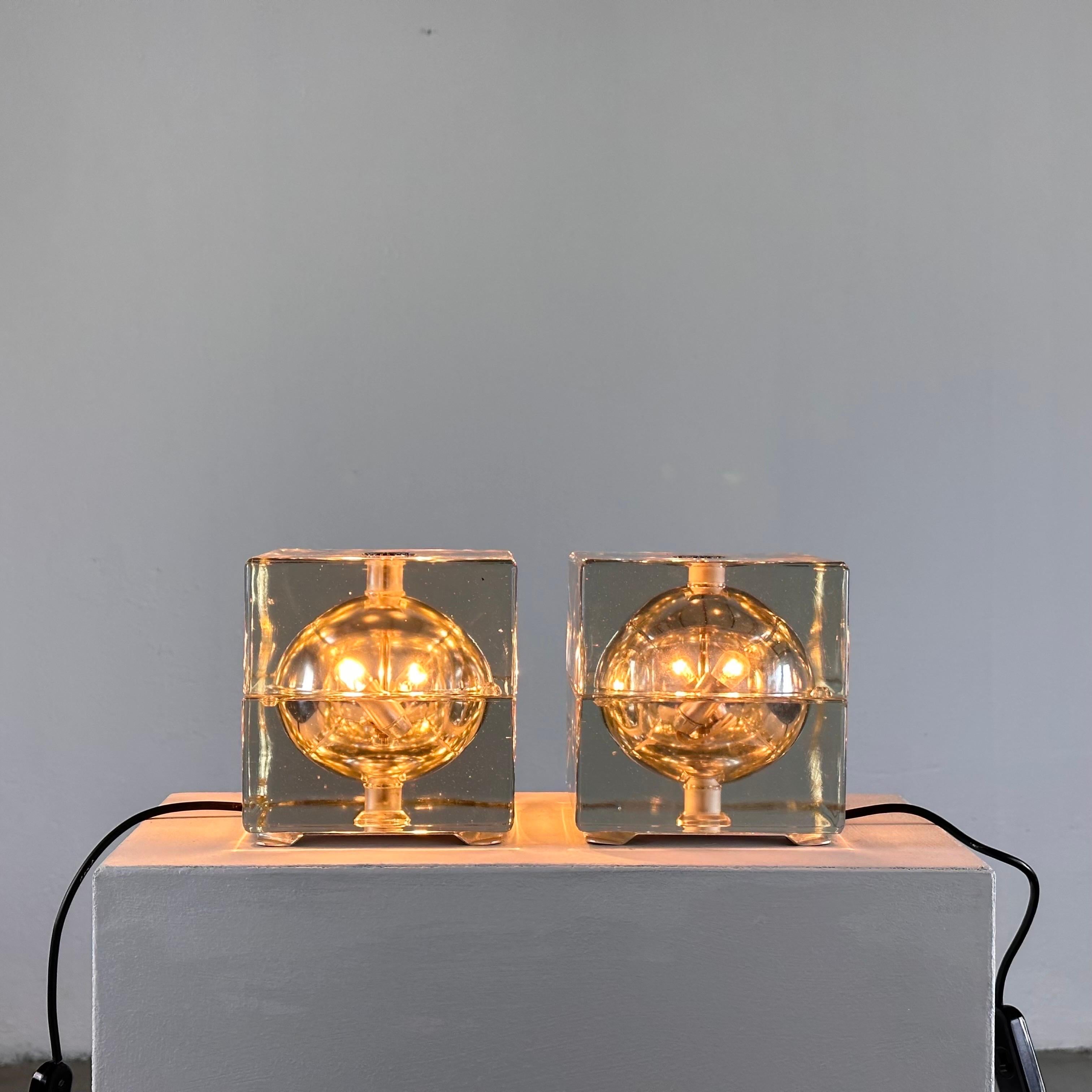 Illuminate your space with iconic mid-century charm embodied in this remarkable pair of Cubosfera table lamps, designed by the legendary Alessandro Mendini for Fidenza Vetraria in the 1960s. These timeless pieces are a testament to Mendini's
