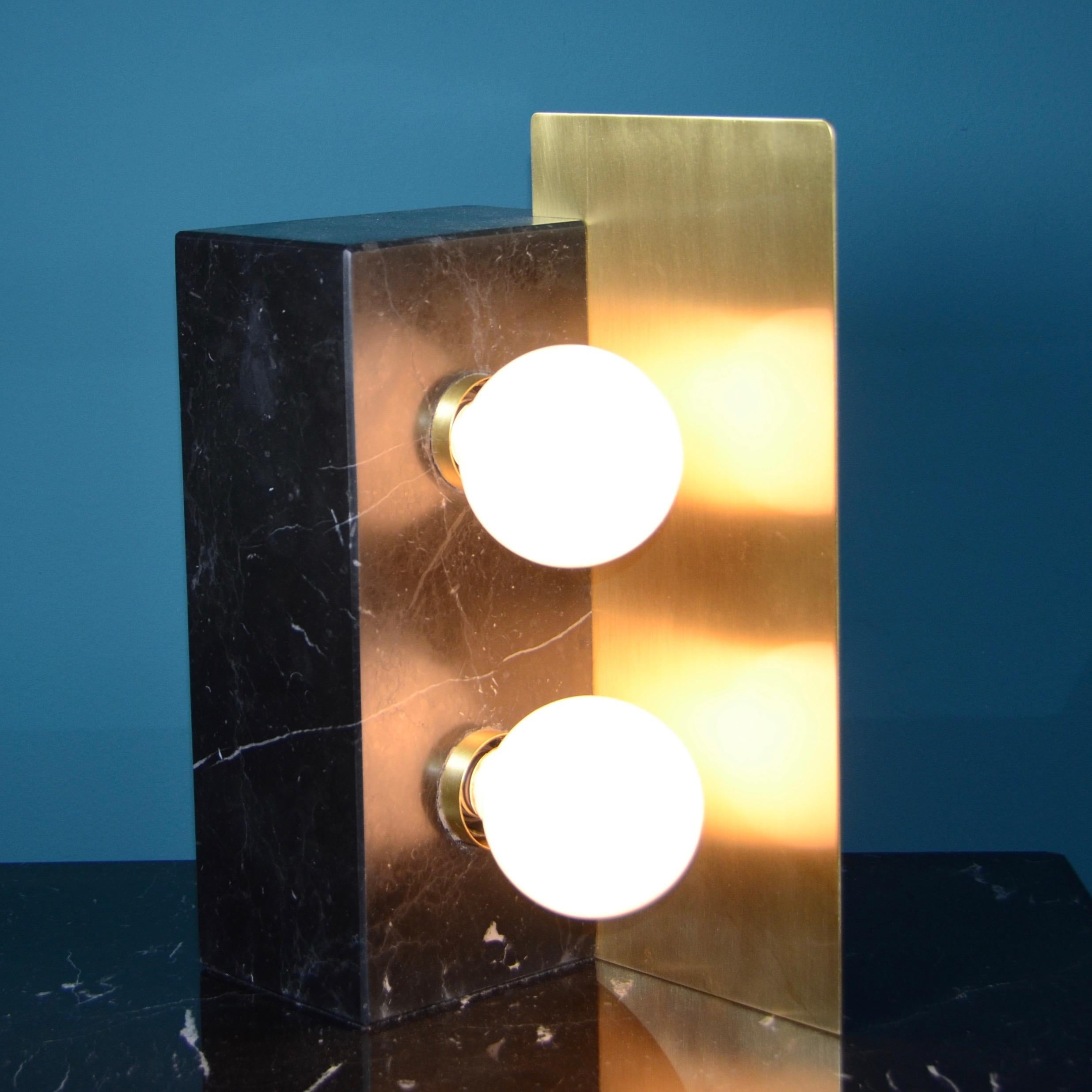 Monolithic table lamp in satin nero Marquinha marble and satin brass with a vintage look.