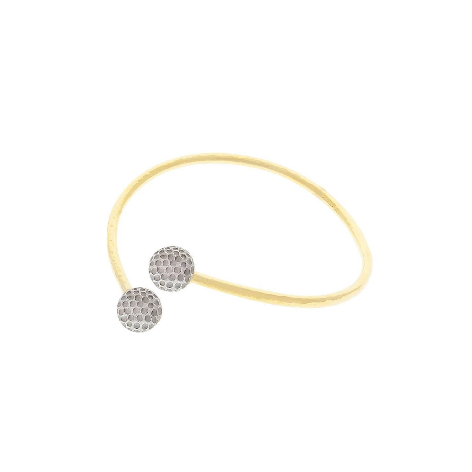 Platinum and 18K yellow gold cuff bracelet with golf ball ends. This bracelet is a must for the avid golfer. Fun and casual.