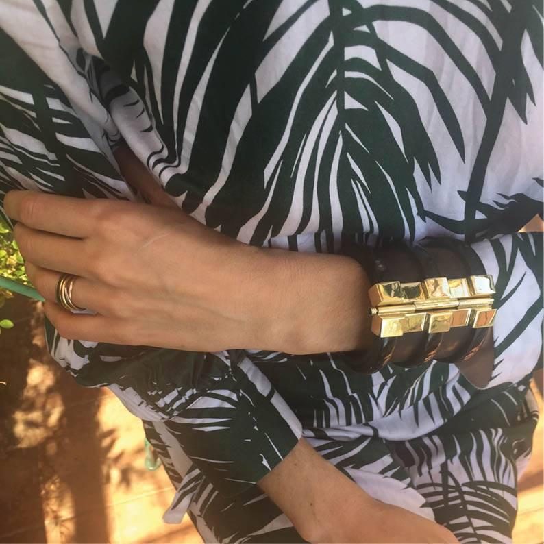 Cuff bracelet hand crafted from African ebony and cow horn. The customizable 18k gold plate pin-clasp is set with a choice of sapphire, ruby or emerald sourced from conflict-free mines in Africa. 

This custom created piece is ready to ship within