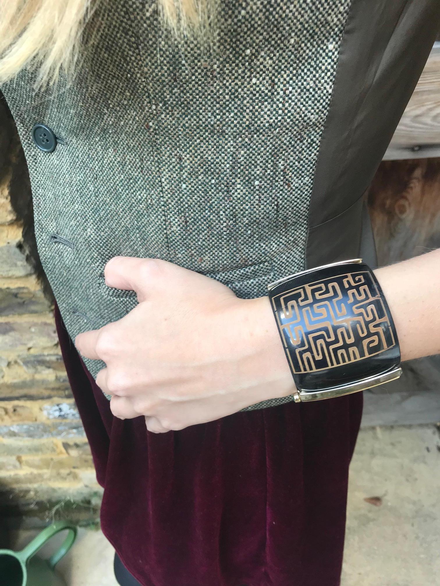 Cuff bracelet hand crafted from African cow horn with Kuba tribal engraving. The intricate pin-clasp is set with a choice or ruby, sapphire or emerald. 

This bespoke piece is available to ship within 2-3 weeks weeks. 

Hand crafted by artisans in