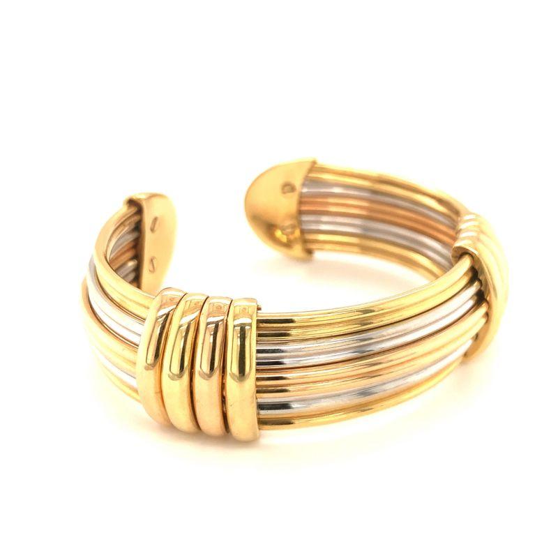 Cuff bracelet in 18K tri-gold (rose, white, yellow) by Luis Gil featuring a stacking gold wire design interspaced with two large fluted yellow gold links. Italian made. 

Sleek, posh, daring.

Additional information:
Metal: 18K rose, white, yellow