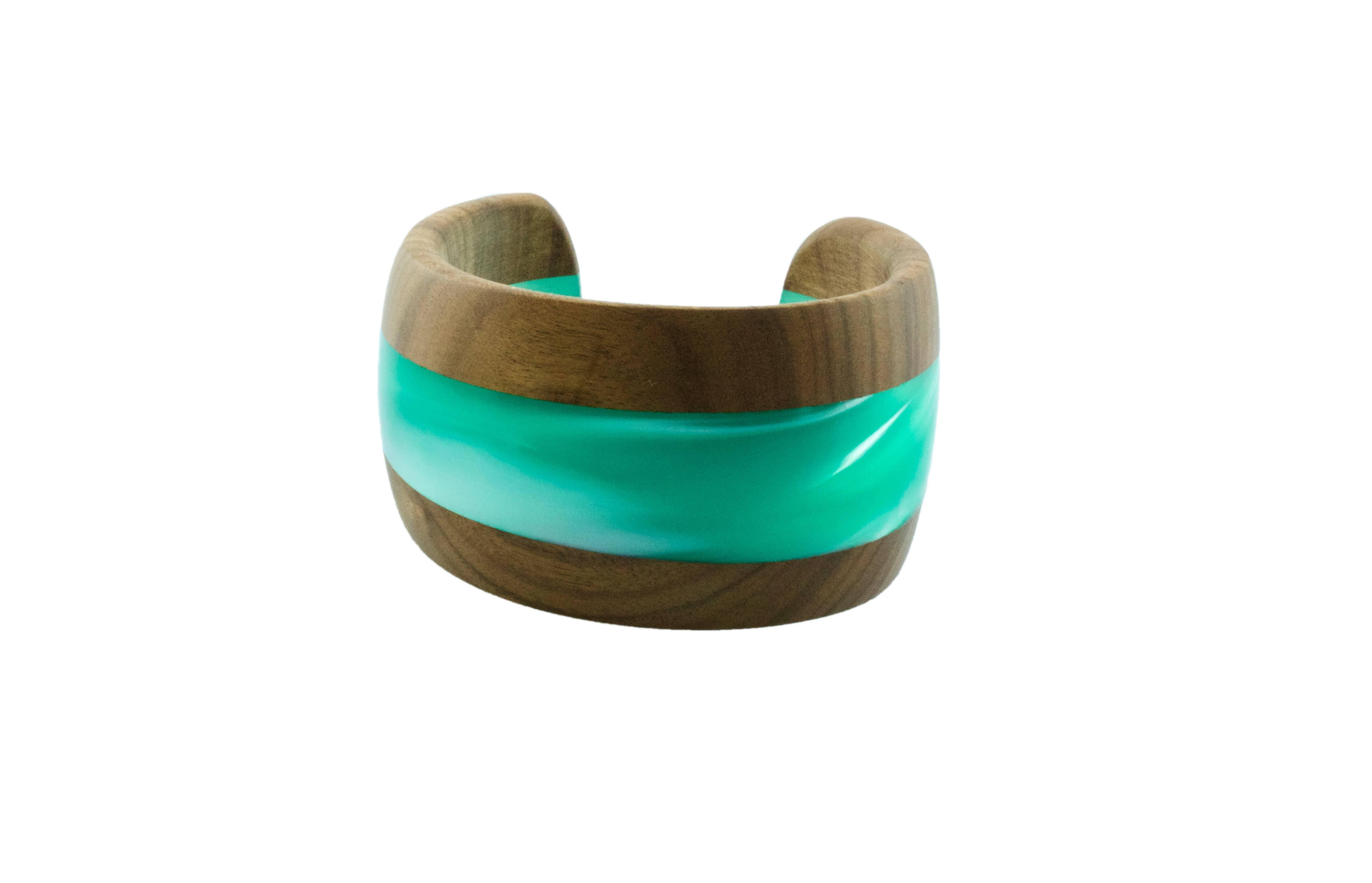 Elegant and modern cuff bracelet totally hand carved made in wood and pearly light blue methacrylate . 