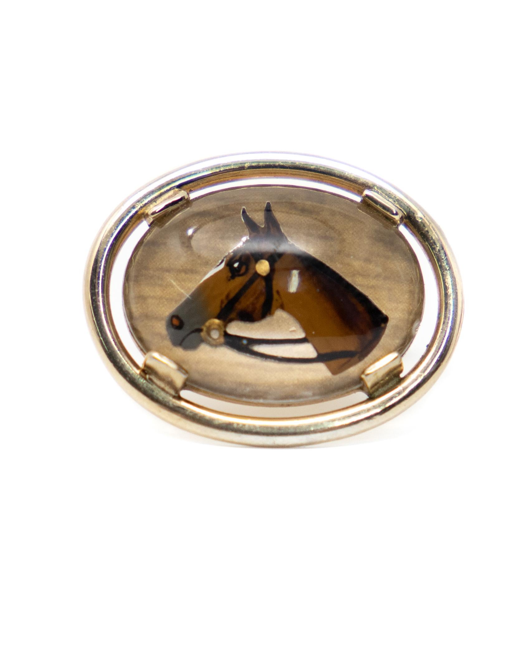 Offering a cool pair of horse head cufflinks by Swank. Gold toned metal with the enameled painting under acrylic.