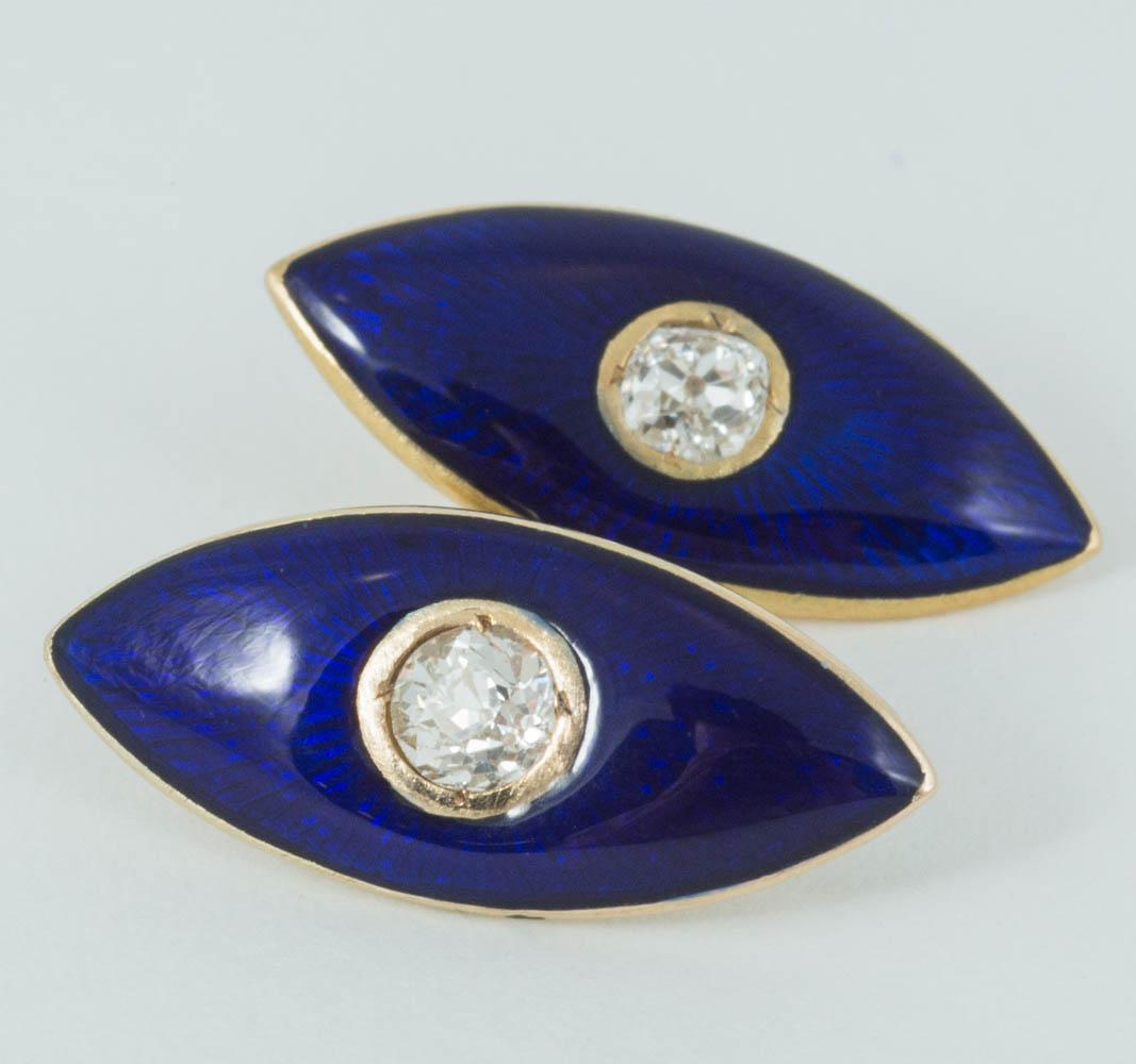 A pair of double sided, antique cufflinks in 18 carat yellow gold. Marquise shaped and faced with blue enamel set with an old cut brilliant diamond centre.
Measures 9mm in width x  22mm in length.
Antique piece (over 100 years old).
Late Victorian,